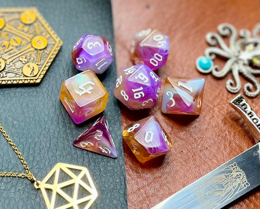 Amethyst Sunset Polyhedral Dice Set  Enter the Fey Wilds with these blue, pink, black and white marbled resin polyhedral dice set.  They are standard 16mm polyhedral dice sets perfect for Tabletop games and RPG's such as pathfinder or dungeons and dragons.  This set includes one of each D20, D12, D10, D%, D8, D6, D4.