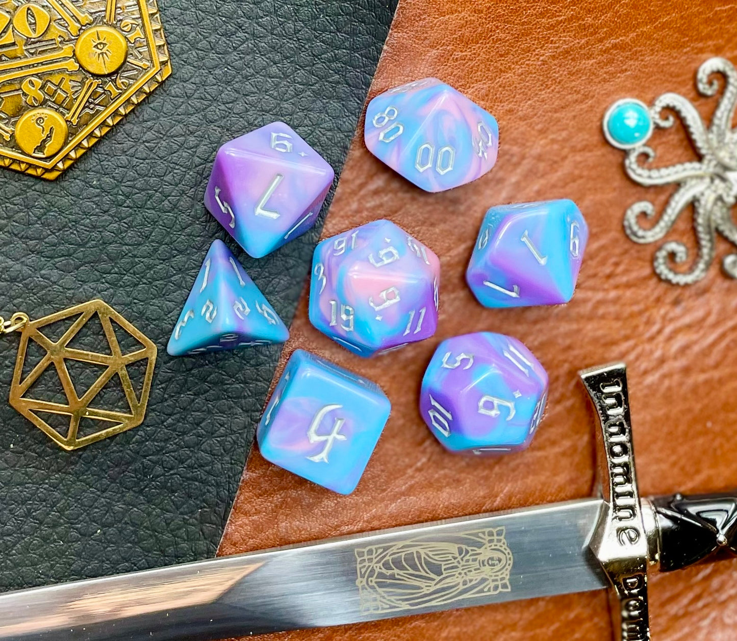 Anemone Polyhedral Dice Set Roll with style with these bubblegum pink and blue marbled resin polyhedral dice set. They are standard 16mm polyhedral dice sets perfect for Tabletop games and RPG's such as pathfinder or dungeons and dragons. This set includes one of each D20, D12, D10, D%, D8, D6, D4.