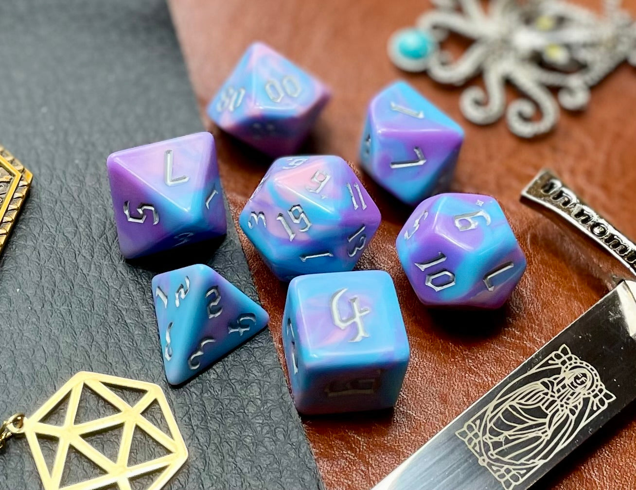 Anemone Polyhedral Dice Set Roll with style with these bubblegum pink and blue marbled resin polyhedral dice set. They are standard 16mm polyhedral dice sets perfect for Tabletop games and RPG's such as pathfinder or dungeons and dragons. This set includes one of each D20, D12, D10, D%, D8, D6, D4.