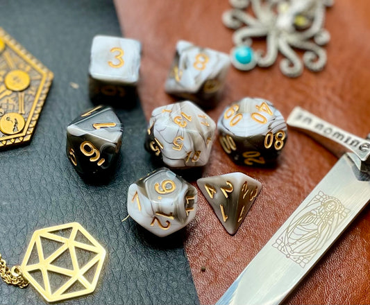Black and White Marble Polyhedral Dice Set  Roll with style with these black and white marbled resin polyhedral dice set.  They are standard 16mm polyhedral dice sets perfect for Tabletop games and RPG's such as pathfinder or dungeons and dragons.  This set includes one of each D20, D12, D10, D%, D8, D6, D4.
