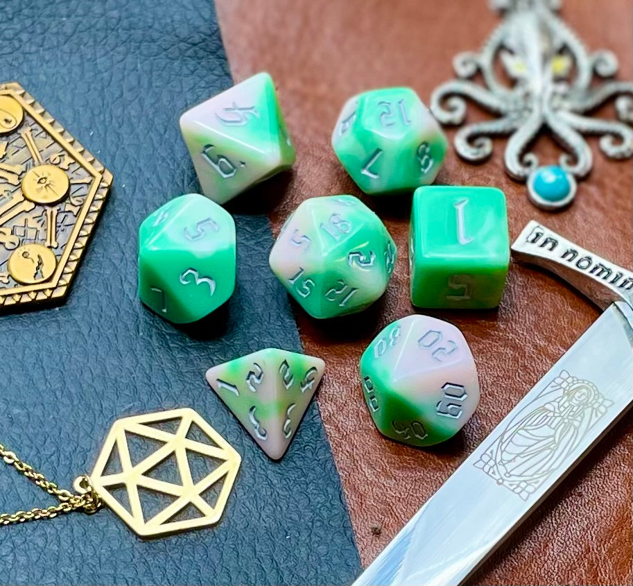 Elemental chaos green and white resin polyhedral dice set. Unleash the fury of the earth elemental spirits with these fantastic resin dice. Combining green and white swirls; each dice has its own unique pattern.