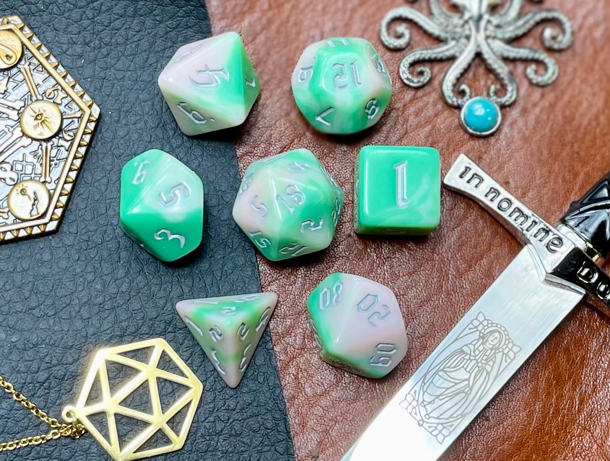 Elemental chaos green and white resin polyhedral dice set. Unleash the fury of the earth elemental spirits with these fantastic resin dice. Combining green and white swirls; each dice has its own unique pattern.