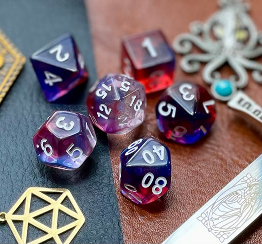 Elemental Gem Tireless Dancer Polyhedral Dice Set  Awaken the elements with these fantastic resin dice. Combining  blue, red and purple translucent resin; each dice has its own unique pattern.  They are standard 16mm polyhedral dice sets perfect for Tabletop games and RPG's such as pathfinder or dungeons and dragons.  This set includes one of each D20, D12, D10, D%, D8, D6, D4.