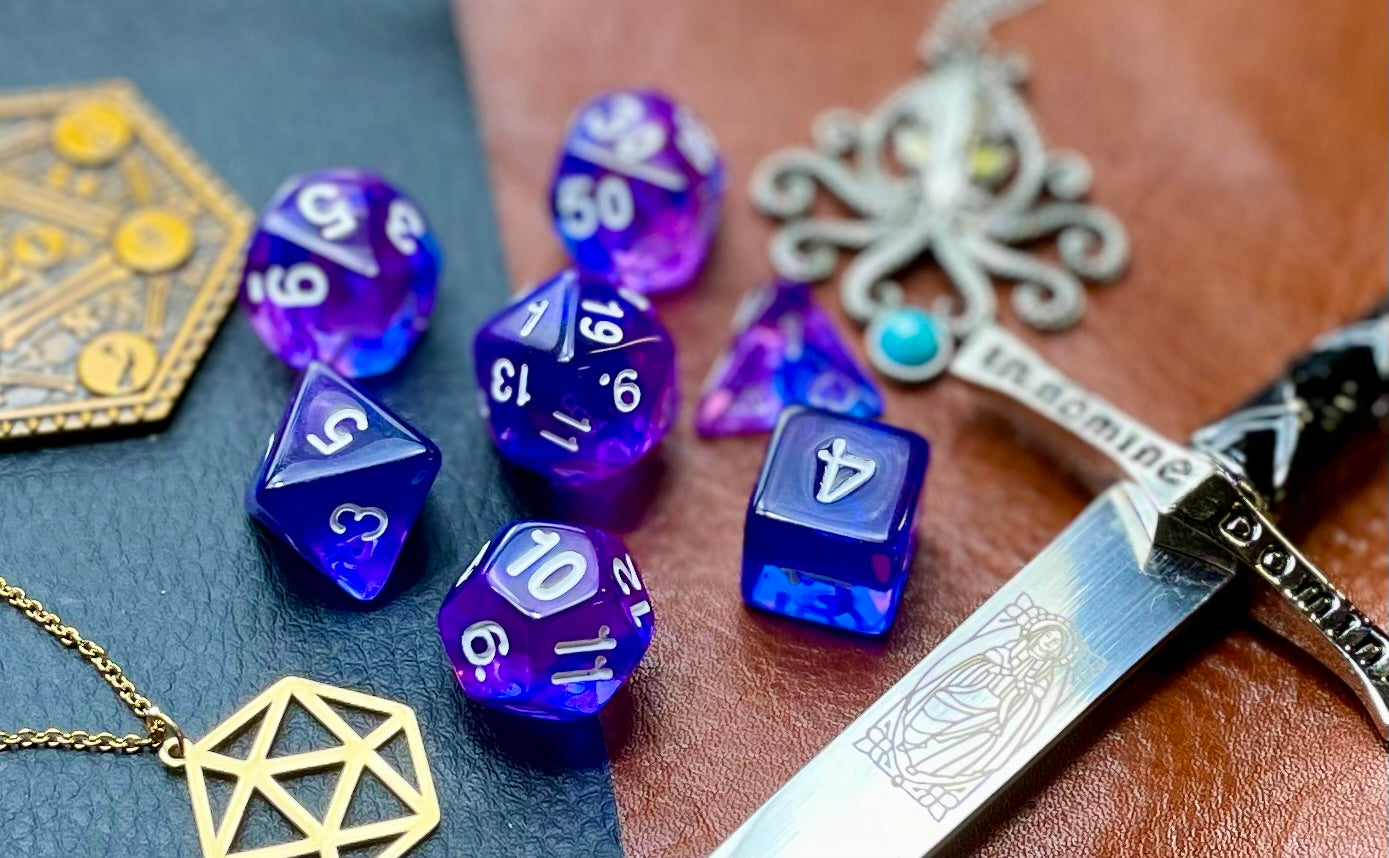 Elemental Indigo Sea resin polyhedral dice set. Delve to the bottom of the fabled Indigo Seas with these fantastic resin dice. Combining translucent green and blues; each dice has its own unique pattern. They are standard 16mm polyhedral dice sets perfect for Tabletop games and RPG's such as pathfinder or dungeons and dragons This set includes one of each D20, D12, D10, D%, D8, D6, D4.