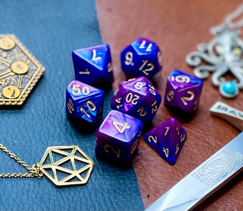 Elemental purple and blue resin polyhedral dice set. Harness the power of the air and water elemental spirits with these fantastic resin dice. Combining blue and copper swirls, each dice has its own unique pattern.