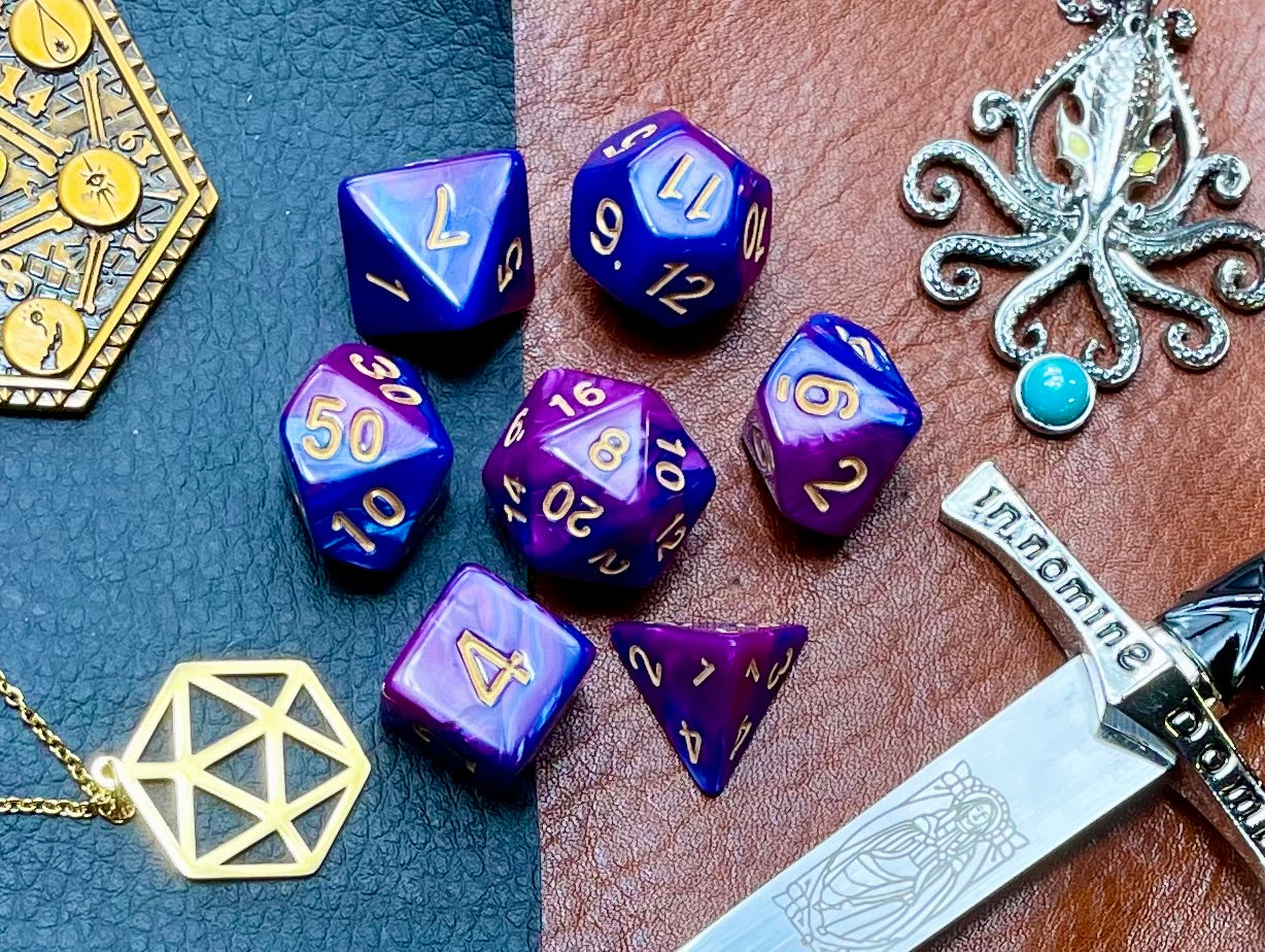 Elemental purple and blue resin polyhedral dice set. Harness the power of the air and water elemental spirits with these fantastic resin dice. Combining blue and copper swirls, each dice has its own unique pattern.