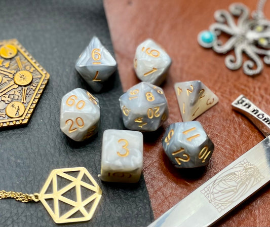 Elemental Steel and White resin polyhedral dice set.  Awaken the elements with these fantastic resin dice. Combining vibrant white and steel swirls; each dice has its own unique pattern.  They are standard 16mm polyhedral dice sets perfect for Tabletop games and RPG's such as pathfinder or dungeons and dragons.  This set includes one of each D20, D12, D10, D%, D8, D6, D4.