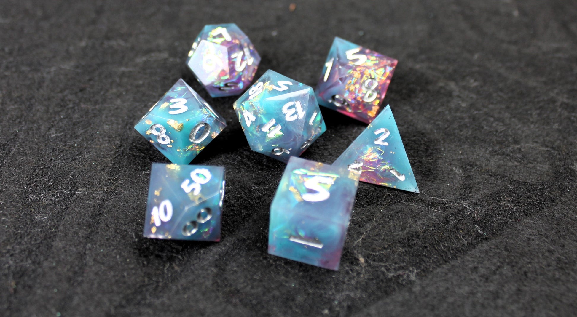Blue and Baby Pink Glitter Sharp Edge Dice Set
Polished luxury sharp edge dice set
Roll in style with these polyhedral dice sets perfect for Tabletop games and RPG's such as pathfinder or dungeons and dragons.
This set includes one of each D20, D12, D10, D%, D8, D6, D4.
Available both with or without a PU leather dice storage box.