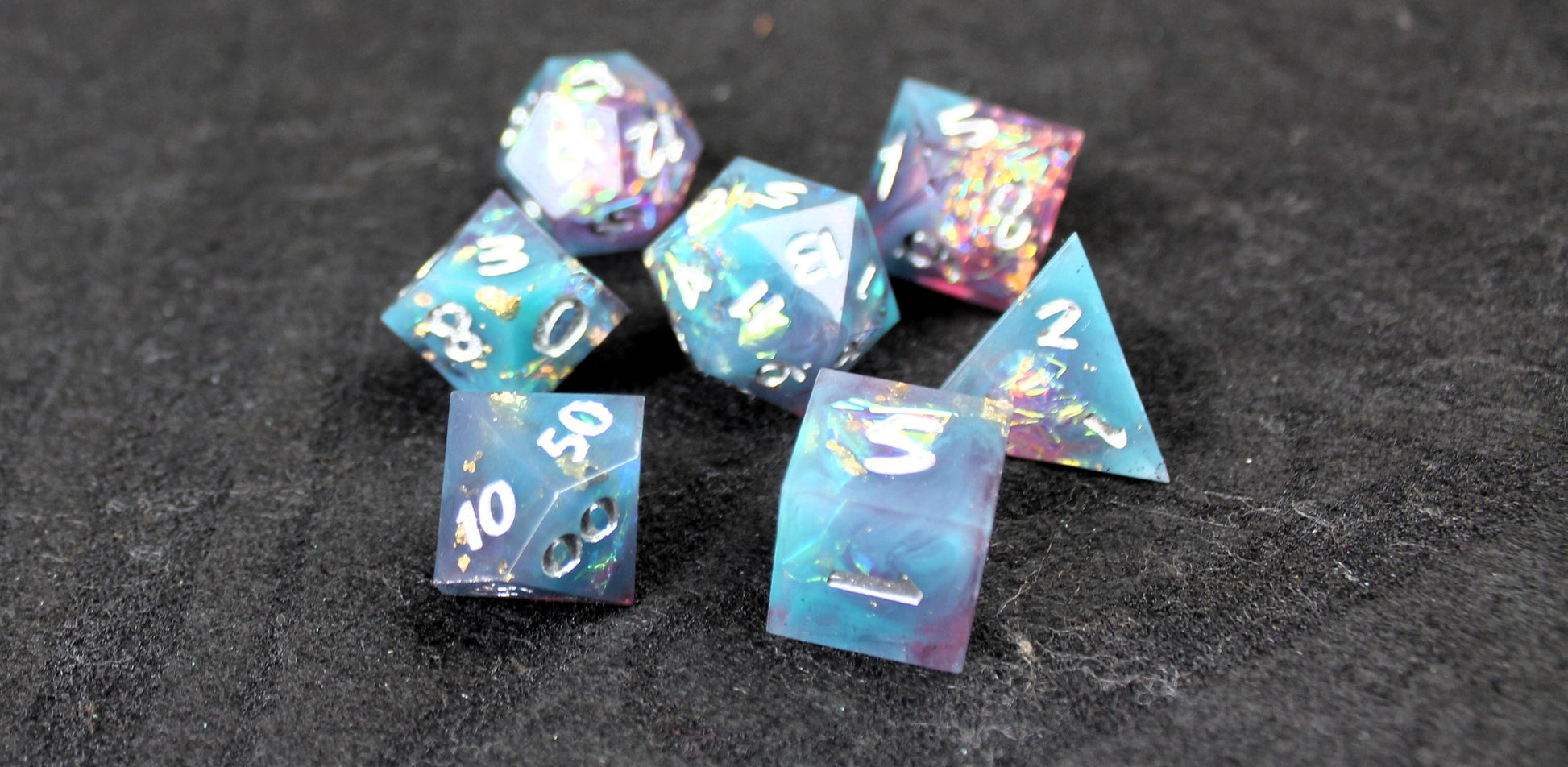 Blue and Baby Pink Glitter Sharp Edge Dice Set
Polished luxury sharp edge dice set
Roll in style with these polyhedral dice sets perfect for Tabletop games and RPG's such as pathfinder or dungeons and dragons.
This set includes one of each D20, D12, D10, D%, D8, D6, D4.
Available both with or without a PU leather dice storage box.