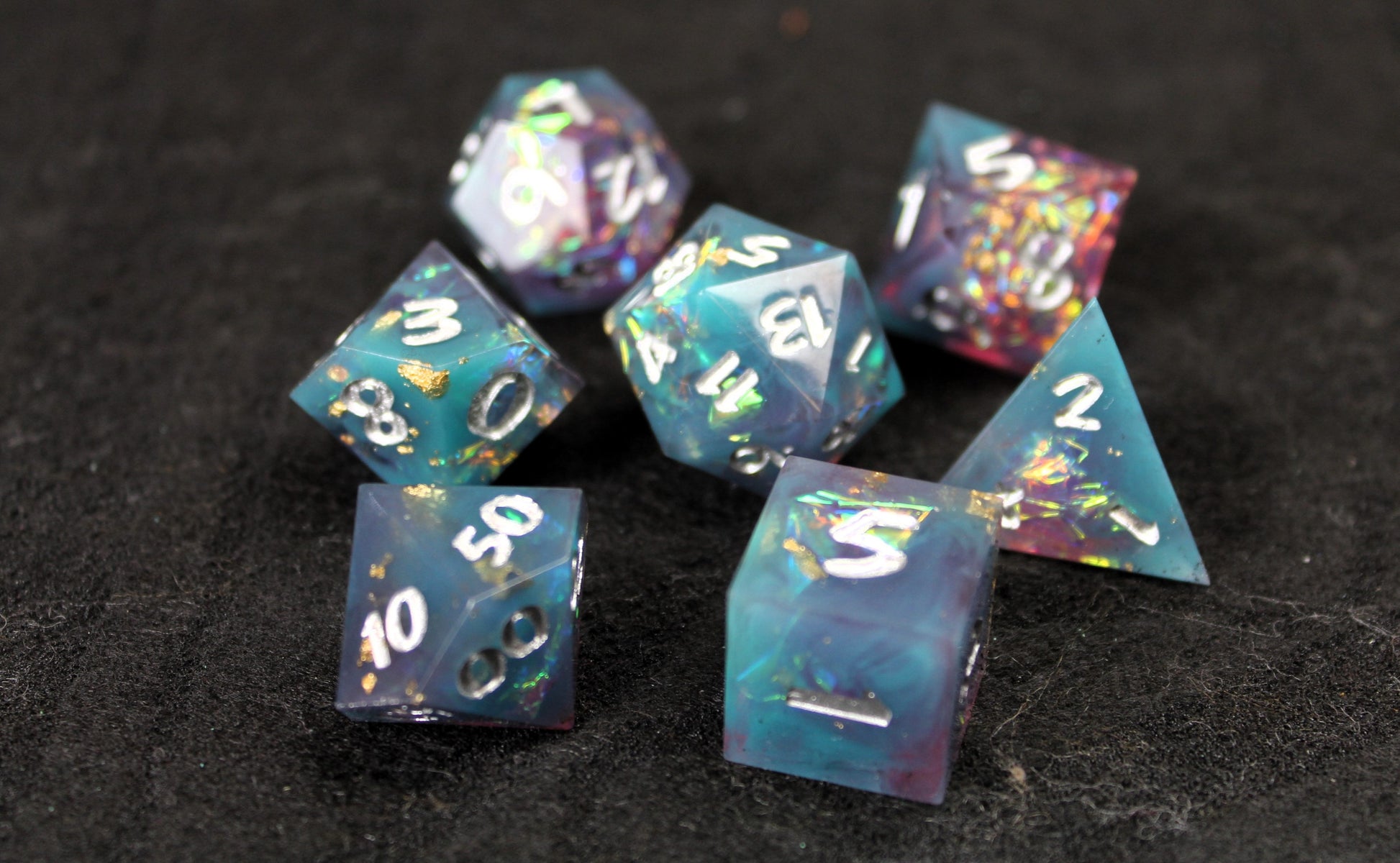 Blue and Baby Pink Glitter Sharp Edge Dice Set
Polished luxury sharp edge dice set
Roll in style with these polyhedral dice sets perfect for Tabletop games and RPG's such as pathfinder or dungeons and dragons.
This set includes one of each D20, D12, D10, D%, D8, D6, D4.
Available both with or without a PU leather dice storage box.