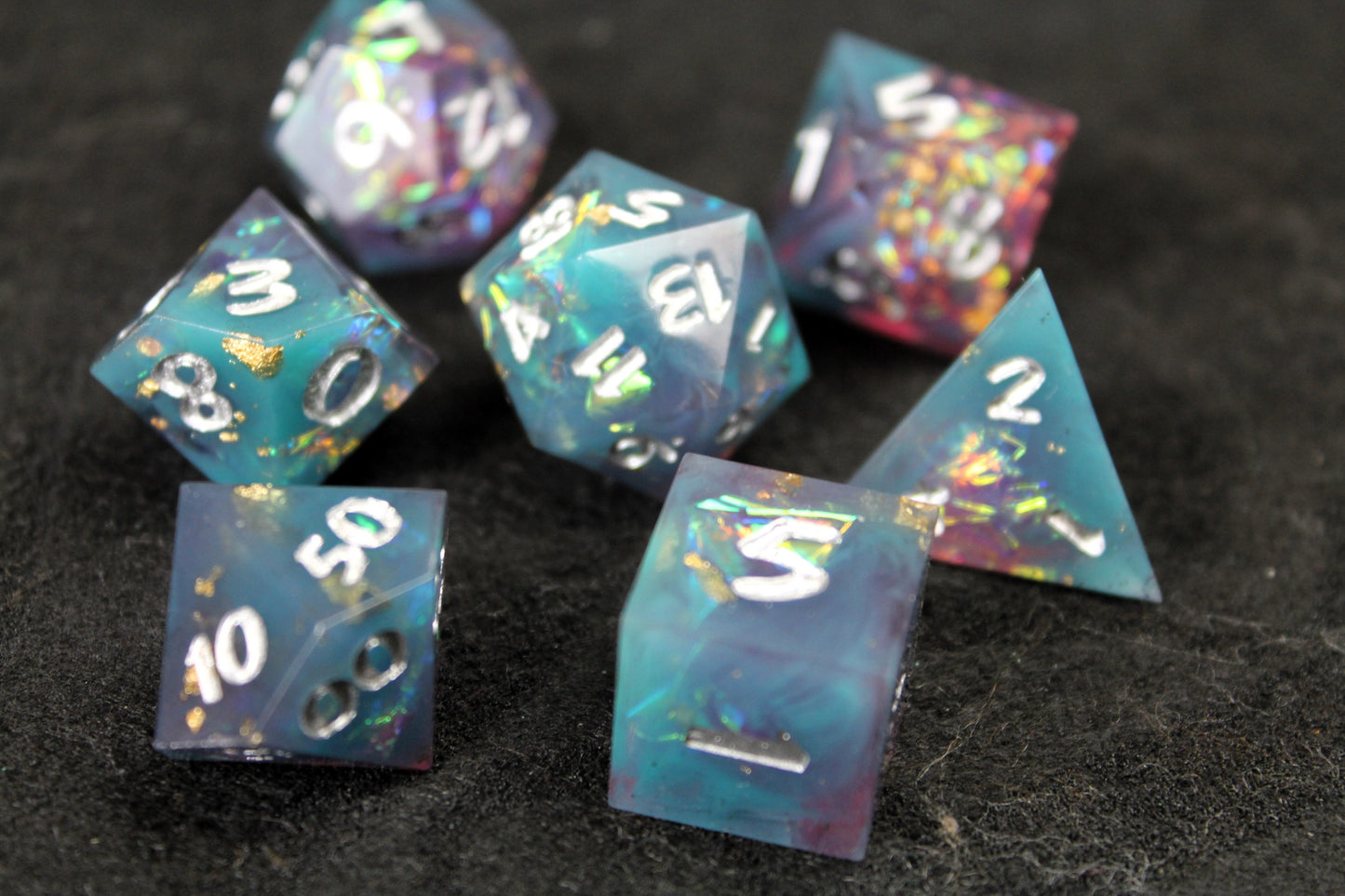 Blue and Baby Pink Glitter Sharp Edge Dice Set
Polished luxury sharp edge dice set
Roll in style with these polyhedral dice sets perfect for Tabletop games and RPG's such as pathfinder or dungeons and dragons.
This set includes one of each D20, D12, D10, D%, D8, D6, D4.
Available both with or without a PU leather dice storage box.