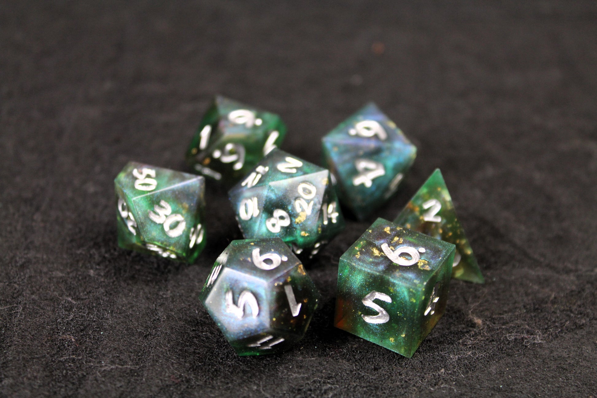 Dark Green Swirl Sharp Edge Dice Set
Polished luxury sharp edge dice set
Roll in style with these polyhedral dice sets perfect for Tabletop games and RPG's such as pathfinder or dungeons and dragons.
This set includes one of each D20, D12, D10, D%, D8, D6, D4.
Available both with or without a PU leather dice storage box.