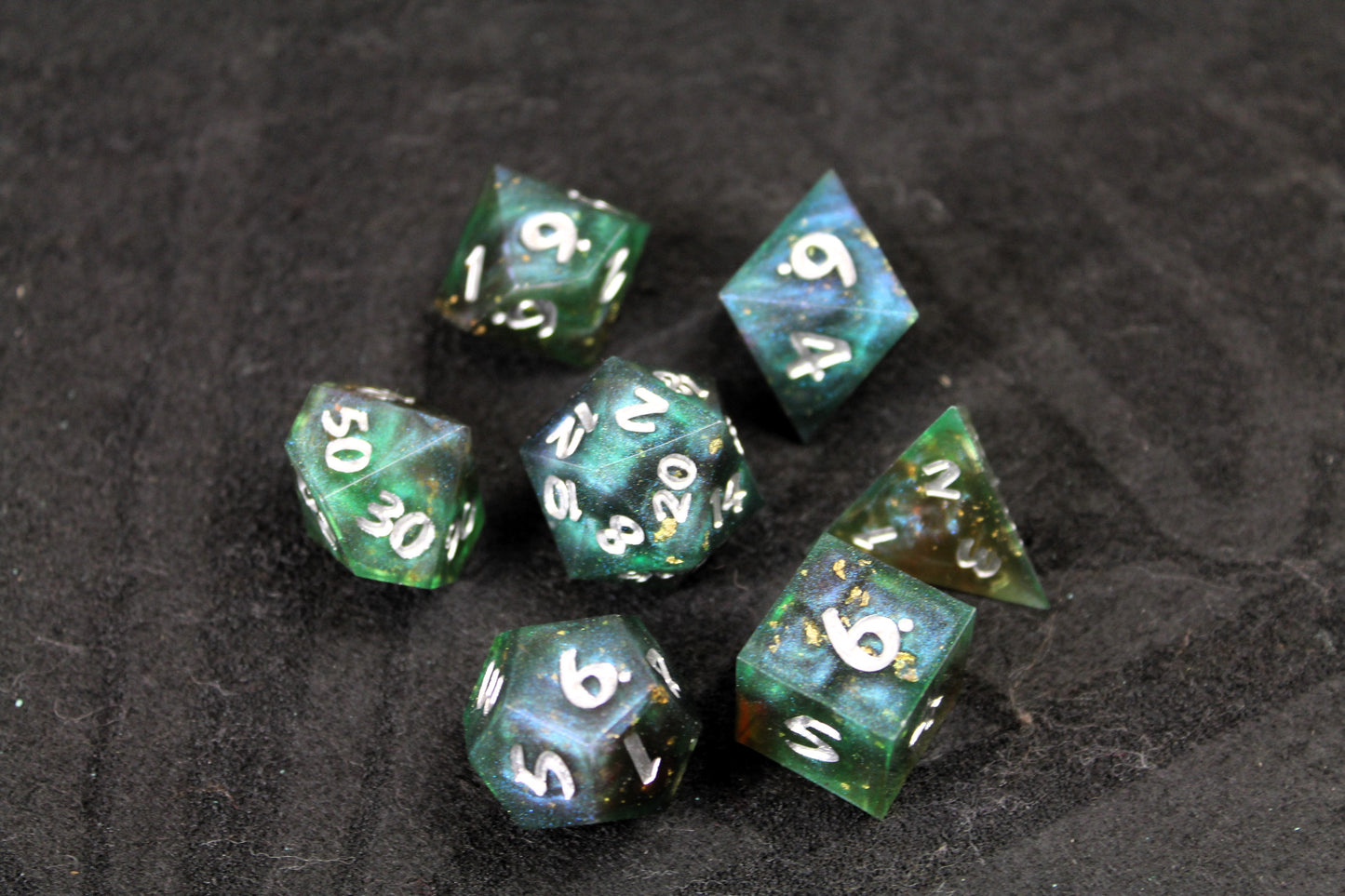 Dark Green Swirl Sharp Edge Dice Set
Polished luxury sharp edge dice set
Roll in style with these polyhedral dice sets perfect for Tabletop games and RPG's such as pathfinder or dungeons and dragons.
This set includes one of each D20, D12, D10, D%, D8, D6, D4.
Available both with or without a PU leather dice storage box.
