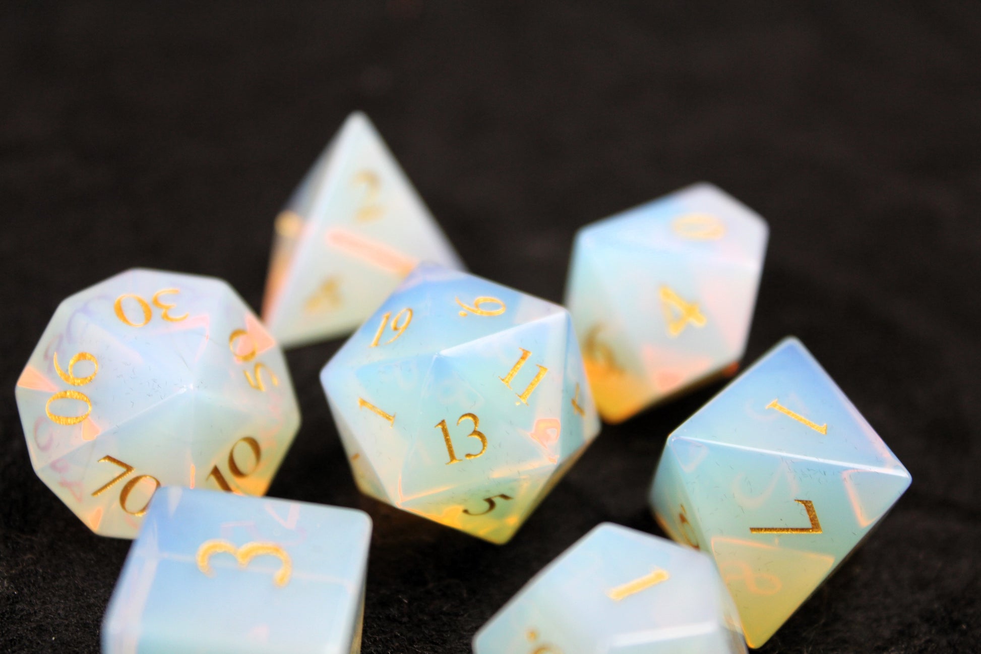 Opalite Gemstone Dice Set
Polished Opalite gemstone with gold numbers dice set
Roll in style with these polyhedral dice sets perfect for Tabletop games and RPG's such as pathfinder or dungeons and dragons.
This set includes one of each D20, D12, D10, D%, D8, D6, D4.
Available both with or without a PU leather dice storage box.