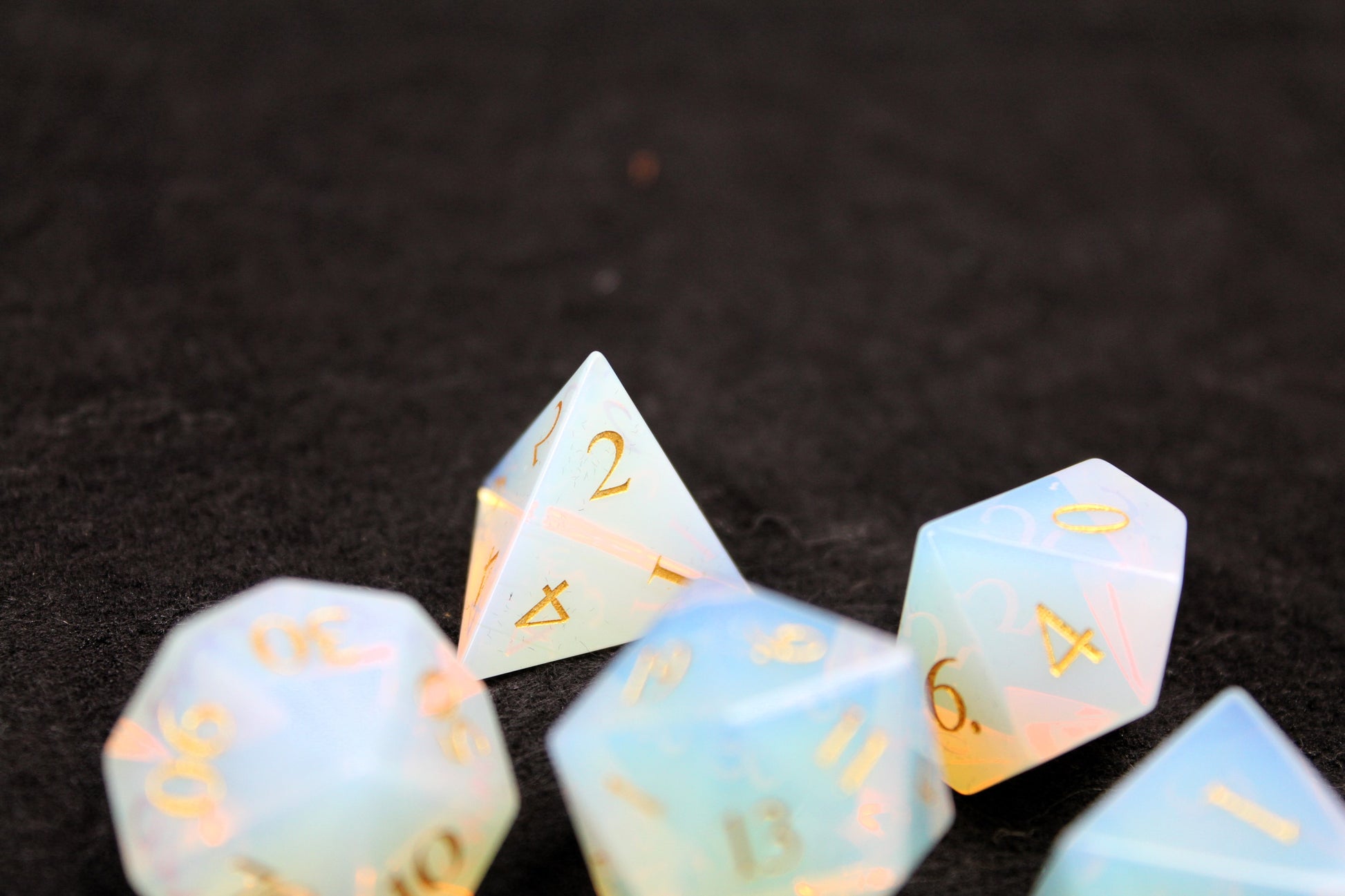 Opalite Gemstone Dice Set
Polished Opalite gemstone with gold numbers dice set
Roll in style with these polyhedral dice sets perfect for Tabletop games and RPG's such as pathfinder or dungeons and dragons.
This set includes one of each D20, D12, D10, D%, D8, D6, D4.
Available both with or without a PU leather dice storage box.