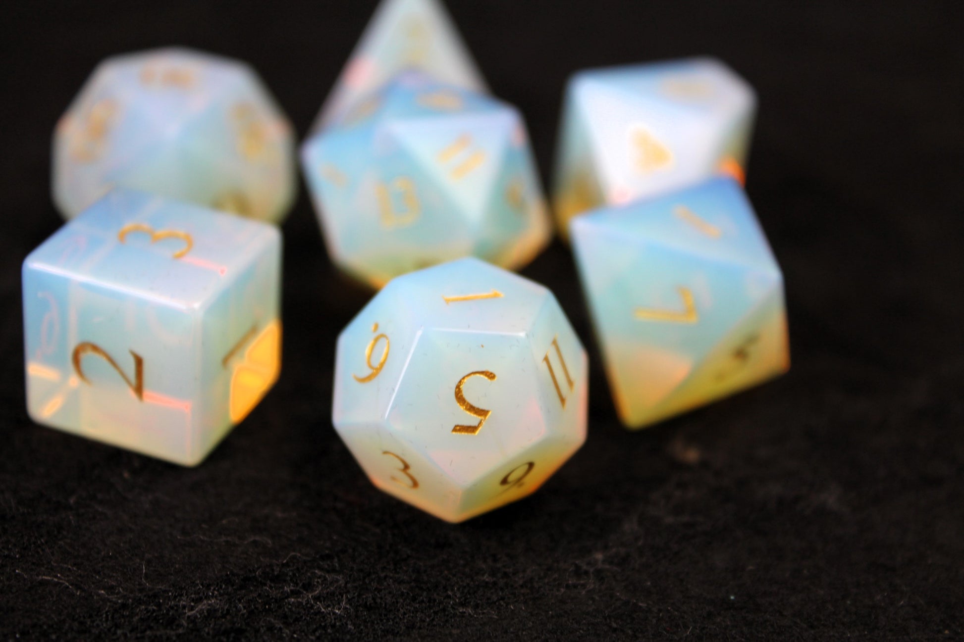 Opalite Gemstone Dice Set
Polished Opalite gemstone with gold numbers dice set
Roll in style with these polyhedral dice sets perfect for Tabletop games and RPG's such as pathfinder or dungeons and dragons.
This set includes one of each D20, D12, D10, D%, D8, D6, D4.
Available both with or without a PU leather dice storage box.