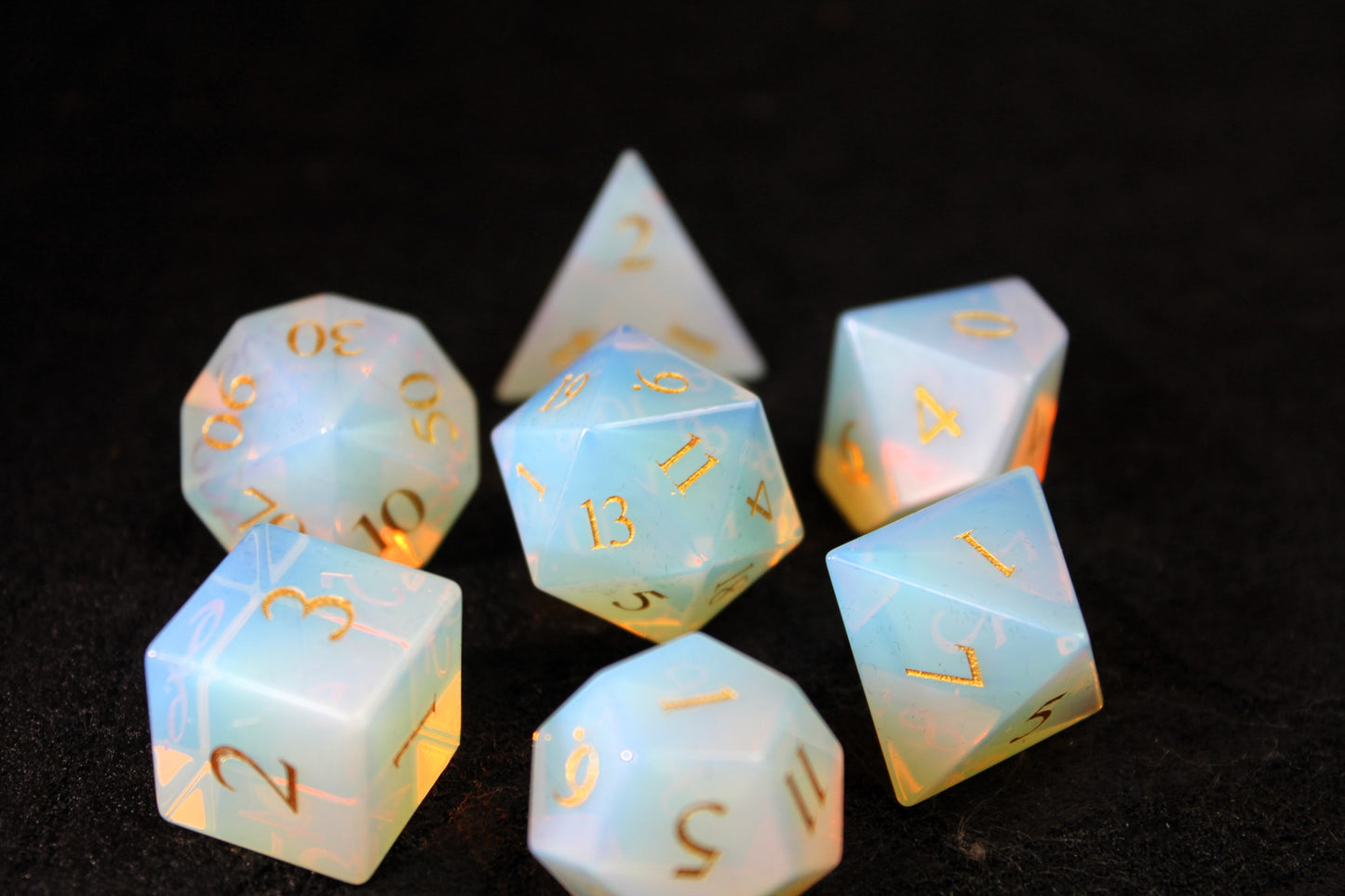 Opalite Gemstone Dice Set
Polished Opalite gemstone with gold numbers dice set
Roll in style with these polyhedral dice sets perfect for Tabletop games and RPG's such as pathfinder or dungeons and dragons.
This set includes one of each D20, D12, D10, D%, D8, D6, D4.
Available both with or without a PU leather dice storage box.