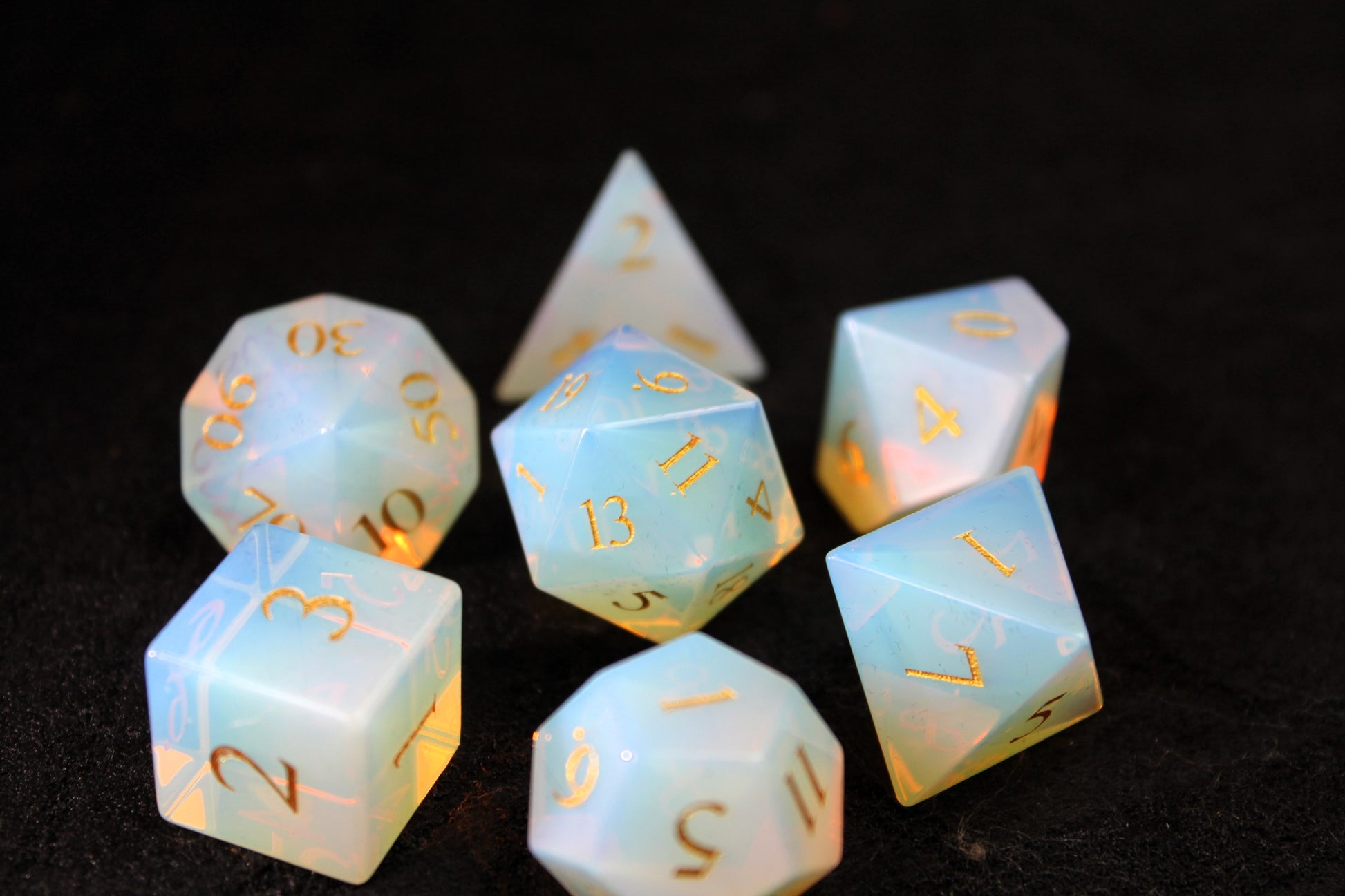 Opalite Gemstone Dice Set
Polished Opalite gemstone with gold numbers dice set
Roll in style with these polyhedral dice sets perfect for Tabletop games and RPG's such as pathfinder or dungeons and dragons.
This set includes one of each D20, D12, D10, D%, D8, D6, D4.
Available both with or without a PU leather dice storage box.