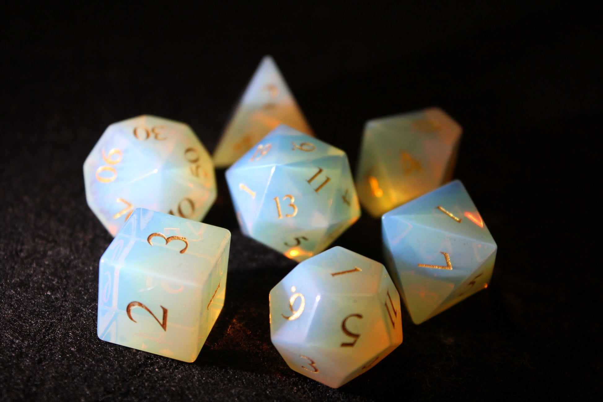 Opalite Gemstone Dice Set
Polished Opalite gemstone with gold numbers dice set
Roll in style with these polyhedral dice sets perfect for Tabletop games and RPG's such as pathfinder or dungeons and dragons.
This set includes one of each D20, D12, D10, D%, D8, D6, D4.
Available both with or without a PU leather dice storage box.