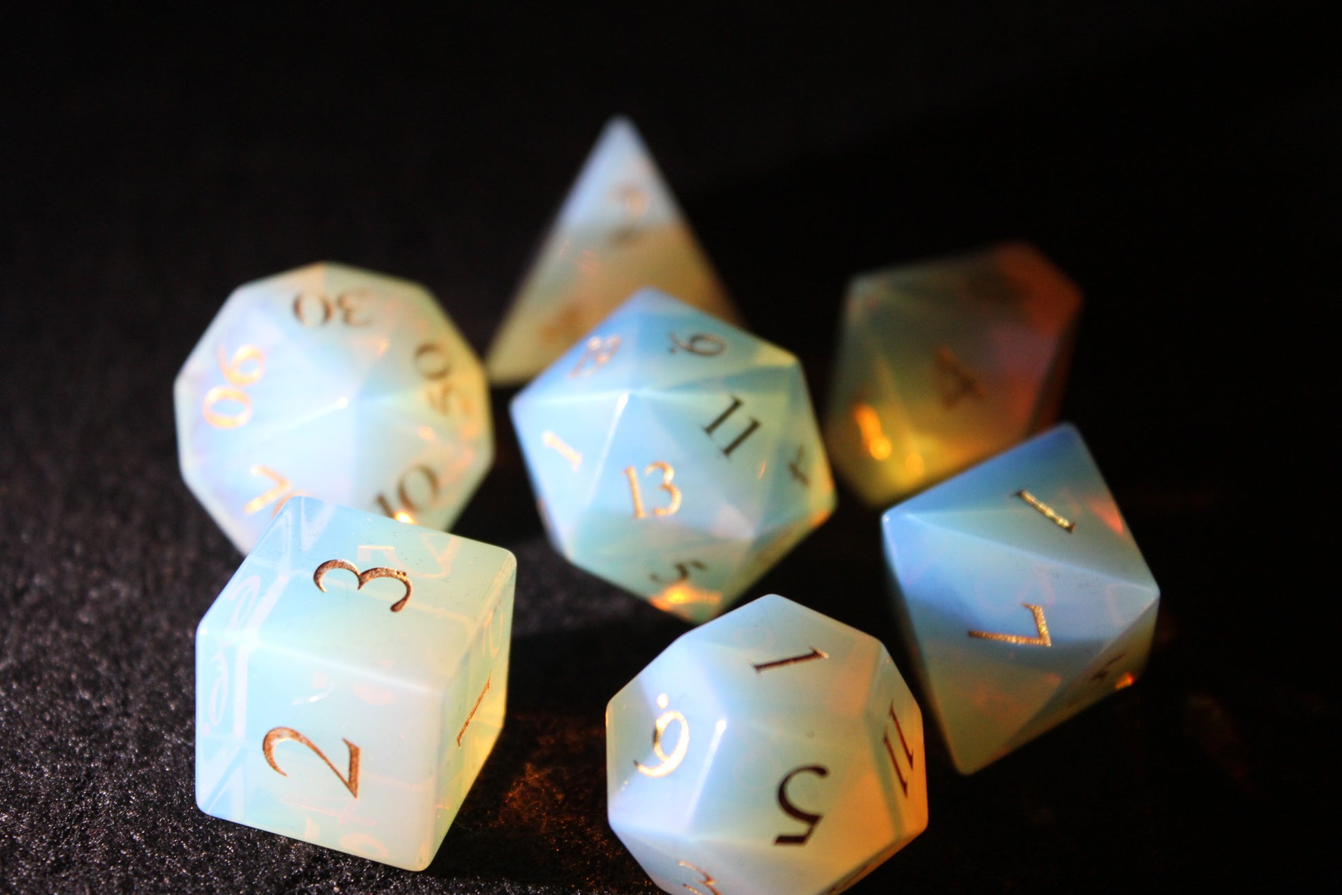 Opalite Gemstone Dice Set
Polished Opalite gemstone with gold numbers dice set
Roll in style with these polyhedral dice sets perfect for Tabletop games and RPG's such as pathfinder or dungeons and dragons.
This set includes one of each D20, D12, D10, D%, D8, D6, D4.
Available both with or without a PU leather dice storage box.