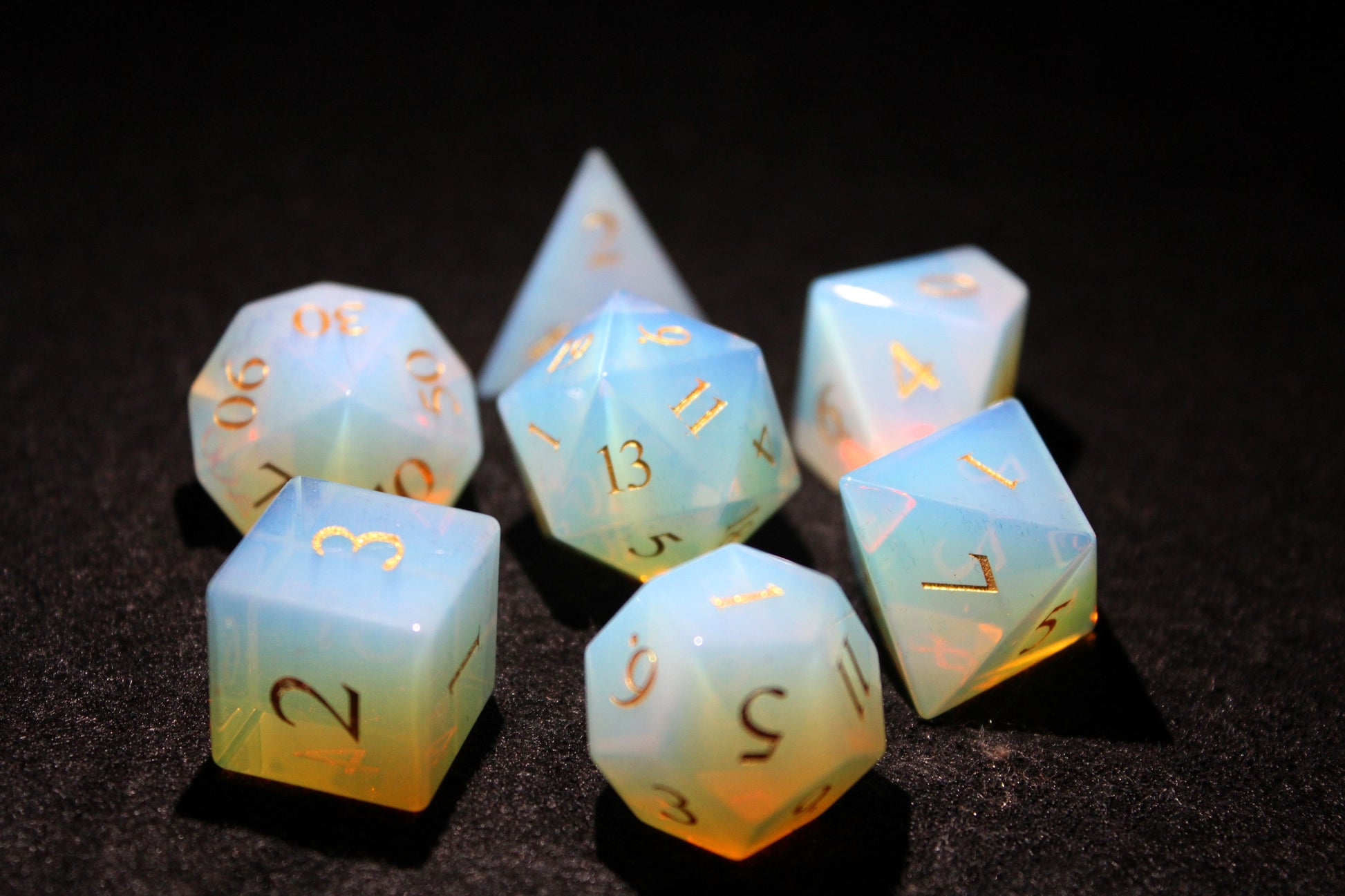 Opalite Gemstone Dice Set
Polished Opalite gemstone with gold numbers dice set
Roll in style with these polyhedral dice sets perfect for Tabletop games and RPG's such as pathfinder or dungeons and dragons.
This set includes one of each D20, D12, D10, D%, D8, D6, D4.
Available both with or without a PU leather dice storage box.