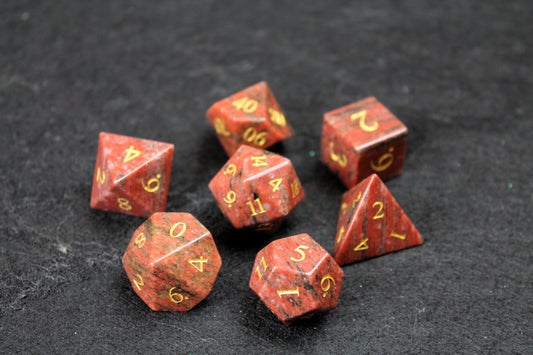 Sesame Red Granite Gemstone Dice Set
Polished Sesame Red Granite gemstone with gold numbers dice set
Roll in style with these polyhedral dice sets perfect for Tabletop games and RPG's such as pathfinder or dungeons and dragons.
This set includes one of each D20, D12, D10, D%, D8, D6, D4.
Available both with or without a PU leather dice storage box.