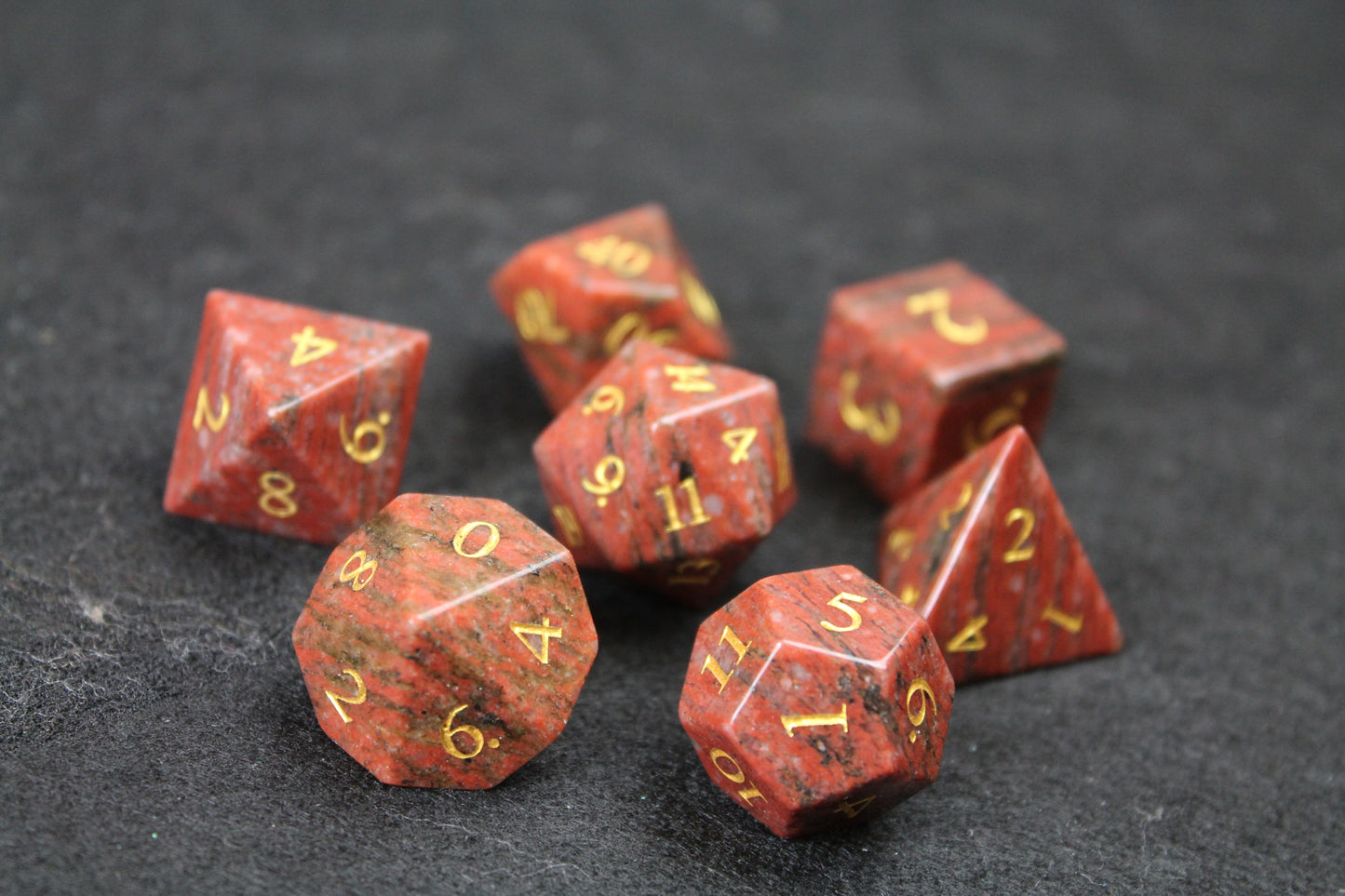 Sesame Red Granite Gemstone Dice Set
Polished Sesame Red Granite gemstone with gold numbers dice set
Roll in style with these polyhedral dice sets perfect for Tabletop games and RPG's such as pathfinder or dungeons and dragons.
This set includes one of each D20, D12, D10, D%, D8, D6, D4.
Available both with or without a PU leather dice storage box.