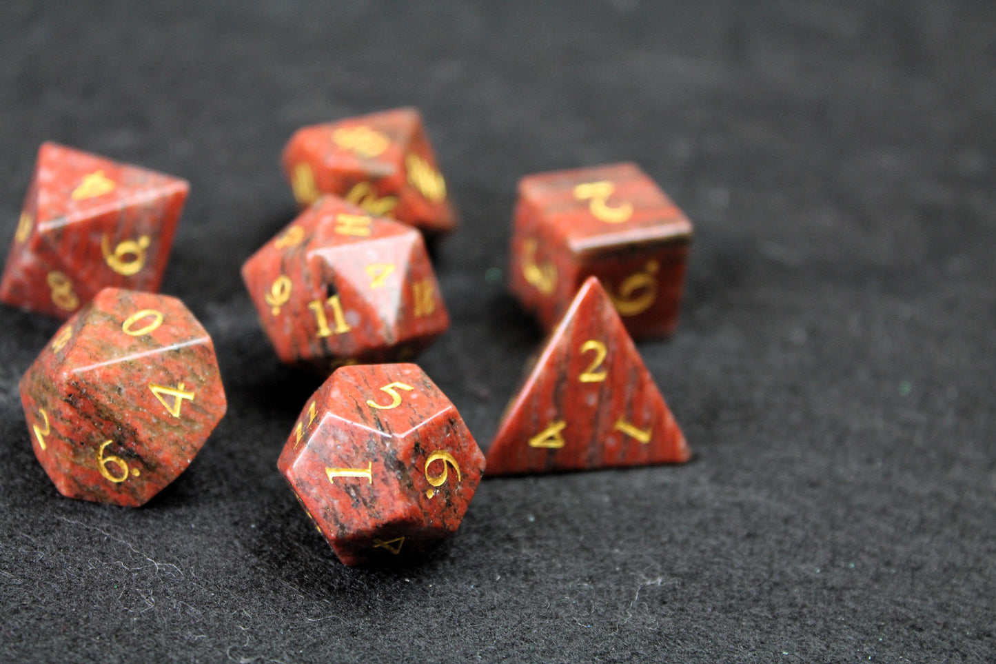 Sesame Red Granite Gemstone Dice Set
Polished Sesame Red Granite gemstone with gold numbers dice set
Roll in style with these polyhedral dice sets perfect for Tabletop games and RPG's such as pathfinder or dungeons and dragons.
This set includes one of each D20, D12, D10, D%, D8, D6, D4.
Available both with or without a PU leather dice storage box.
