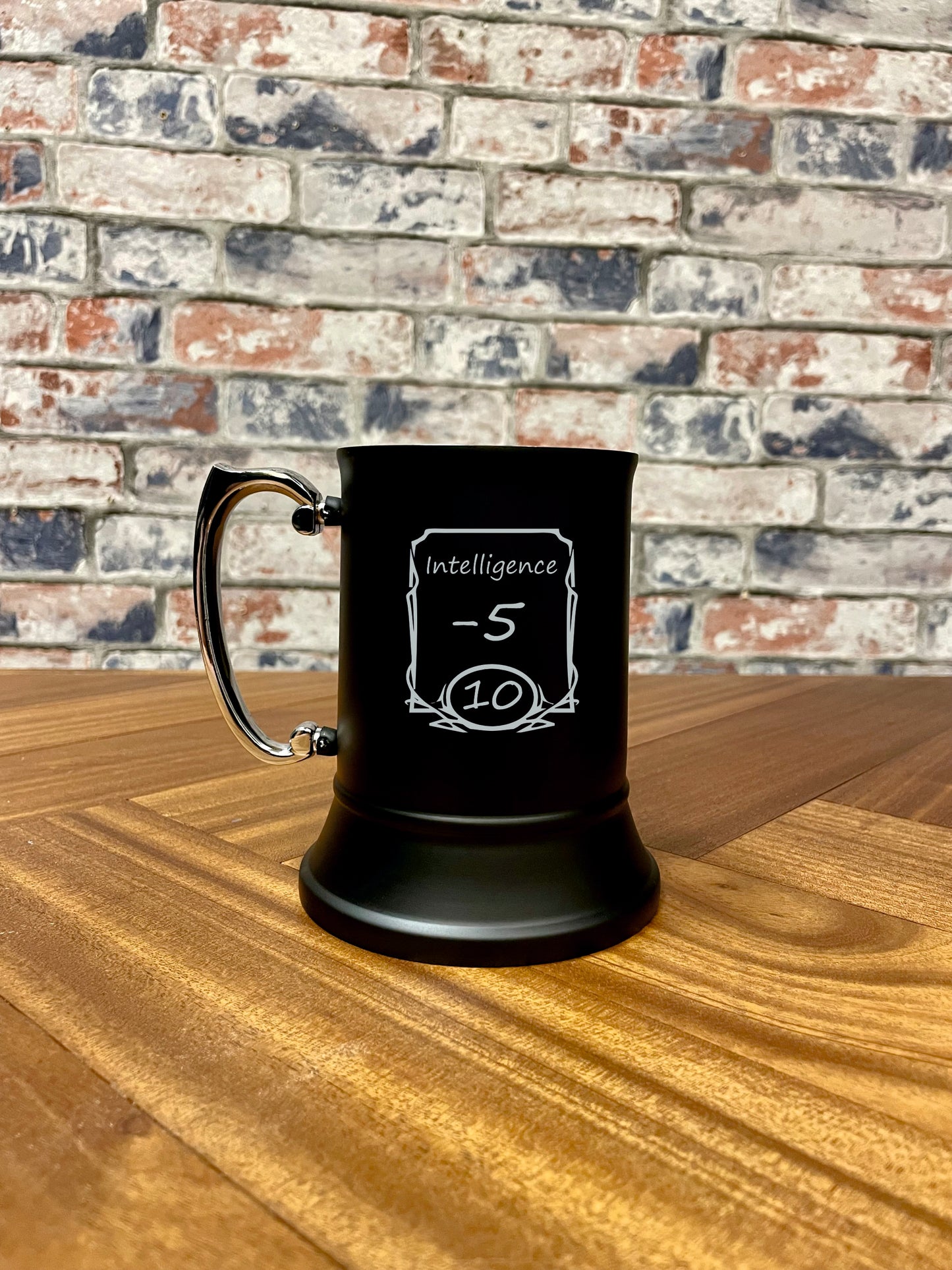 Intelligence -5 Engraved stainless steel drinking tankard.
Black enameled tankard engraved with fun Intelligence -5 stats change design.
Standing 13cm tall and holding 500ml, you'll stay refreshed during even the most tense combat!
By engraving the coating off the stainless steel it wont fade or wear; keeping your tankard looking its best for longer.
Perfect for tabletop gaming, dungeons and dragons TTRPG's, LARP and much more. Treat yourself and your party!