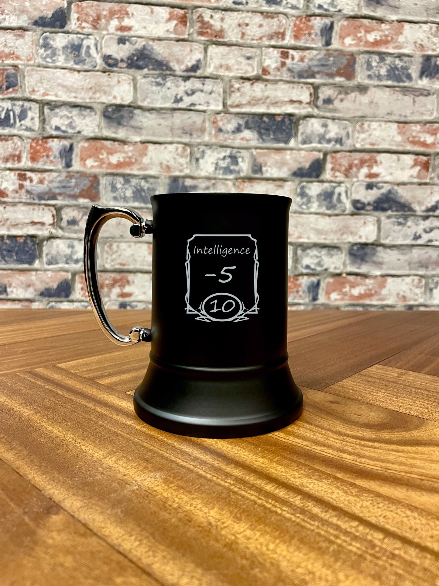Intelligence -5 Engraved stainless steel drinking tankard.
Black enameled tankard engraved with fun Intelligence -5 stats change design.
Standing 13cm tall and holding 500ml, you'll stay refreshed during even the most tense combat!
By engraving the coating off the stainless steel it wont fade or wear; keeping your tankard looking its best for longer.
Perfect for tabletop gaming, dungeons and dragons TTRPG's, LARP and much more. Treat yourself and your party!