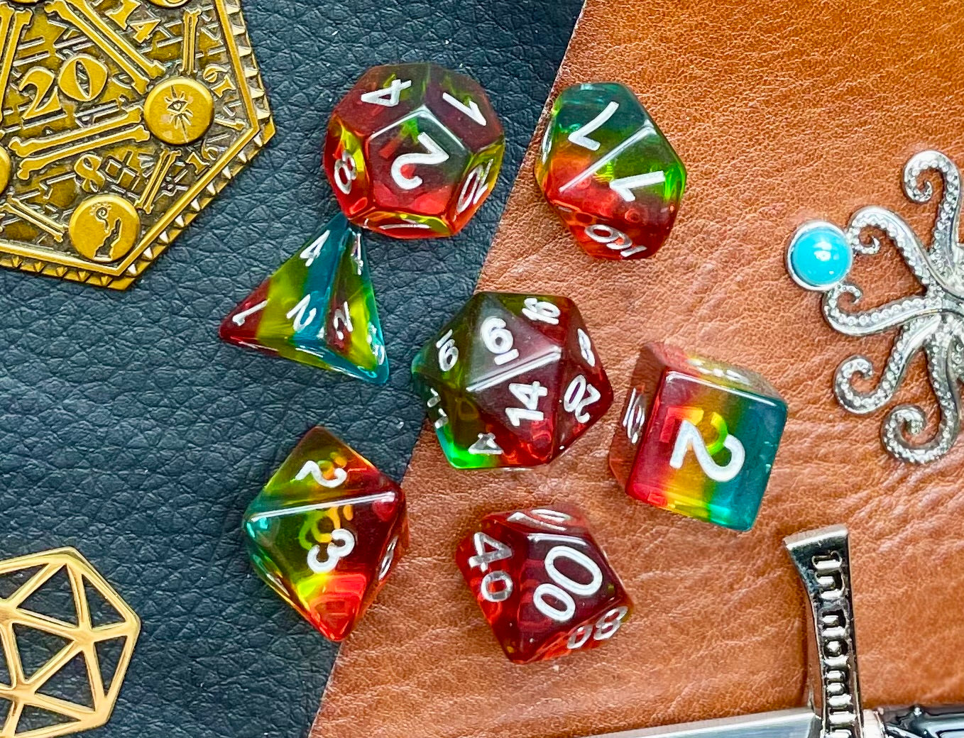 Pride glitter resin polyhedral dice set. Yet another reason to add to your growing dice collection with these fantastic resin dice. These are beautiful translucent dice featuring a range of reds, yellows and blues with gold glitter running throughout. They are standard 16mm polyhedral dice sets perfect for Tabletop games and RPG's such as pathfinder or dungeons and dragons. This set includes one of each D20, D12, D10, D%, D8, D6, D4.