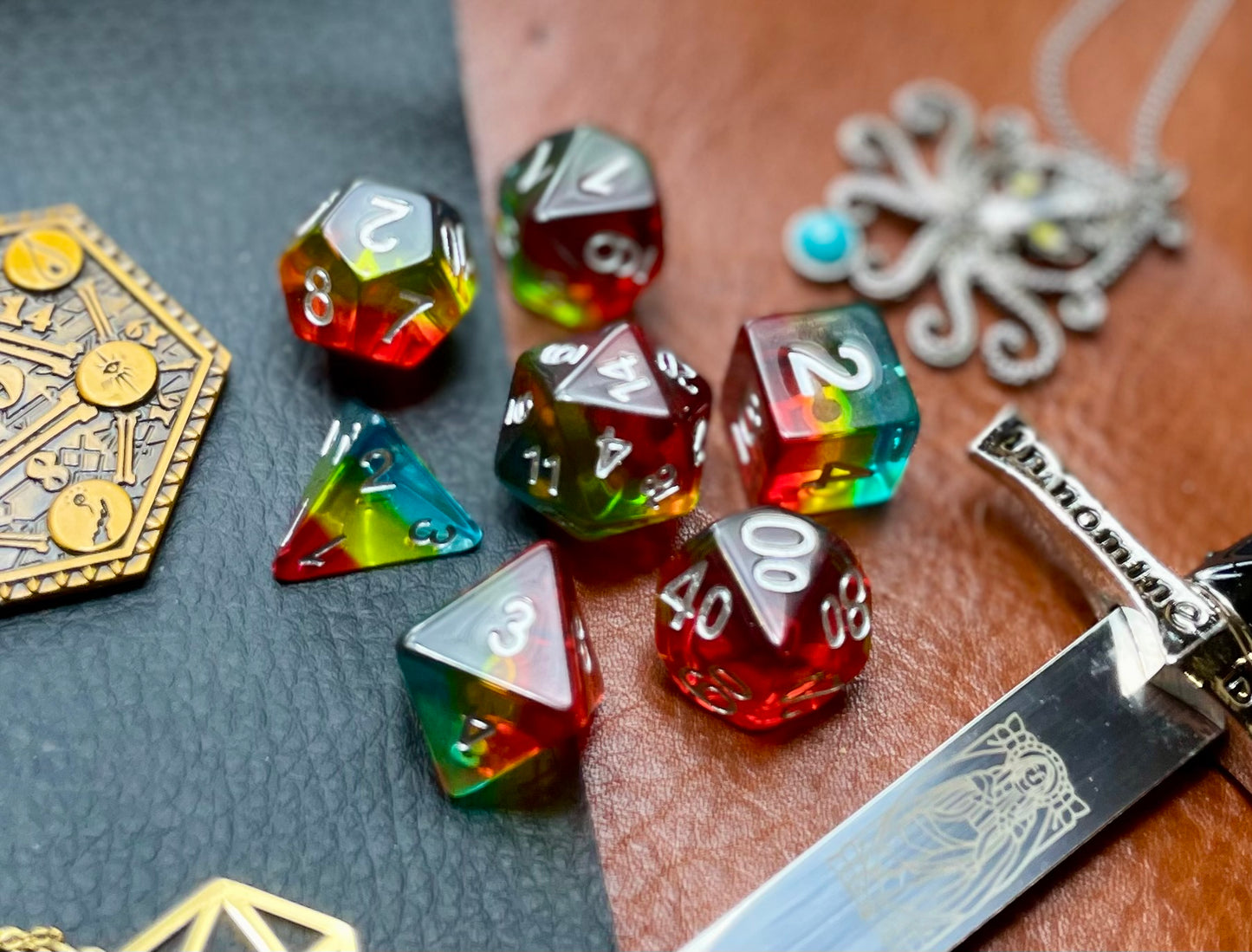 Pride glitter resin polyhedral dice set. Yet another reason to add to your growing dice collection with these fantastic resin dice. These are beautiful translucent dice featuring a range of reds, yellows and blues with gold glitter running throughout. They are standard 16mm polyhedral dice sets perfect for Tabletop games and RPG's such as pathfinder or dungeons and dragons. This set includes one of each D20, D12, D10, D%, D8, D6, D4.