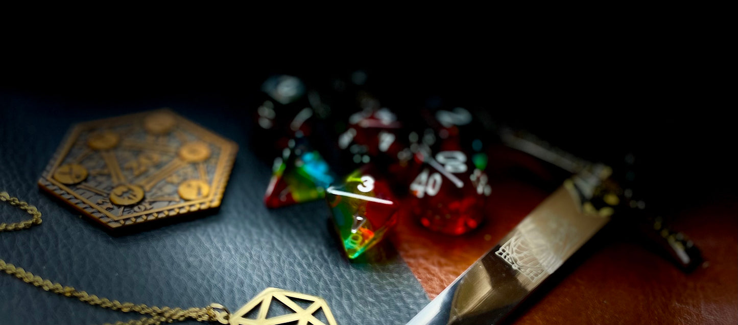 Pride glitter resin polyhedral dice set. Yet another reason to add to your growing dice collection with these fantastic resin dice. These are beautiful translucent dice featuring a range of reds, yellows and blues with gold glitter running throughout. They are standard 16mm polyhedral dice sets perfect for Tabletop games and RPG's such as pathfinder or dungeons and dragons. This set includes one of each D20, D12, D10, D%, D8, D6, D4.