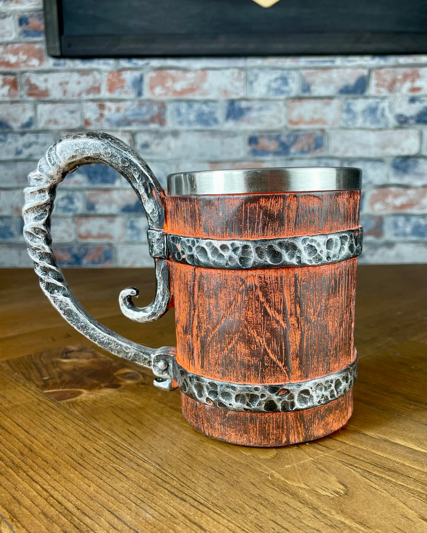 Medieval Viking Style Decorative Resin Drinking Tankard With Stainless Steel Insert. Drink in style with our highly decorative tankard with wood effect panels, metal banding and rustic style handle. Holding 500ml you can drink with your clan in style. Perfect for decorating home bars, cosplay, tabletop gaming and all fans of Norse mythology and Viking decoration.