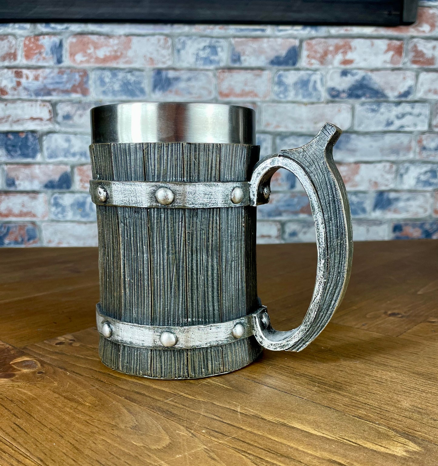 Medieval Viking Style Decorative Resin Drinking Tankard With Stainless Steel Insert. Drink in style with our highly decorative tankard with wood effect panels, metal banding and rustic style handle. Holding 500ml you can drink with your clan in style. Perfect for decorating home bars, cosplay, tabletop gaming and all fans of Norse mythology, and medieval and fantasy decoration.
