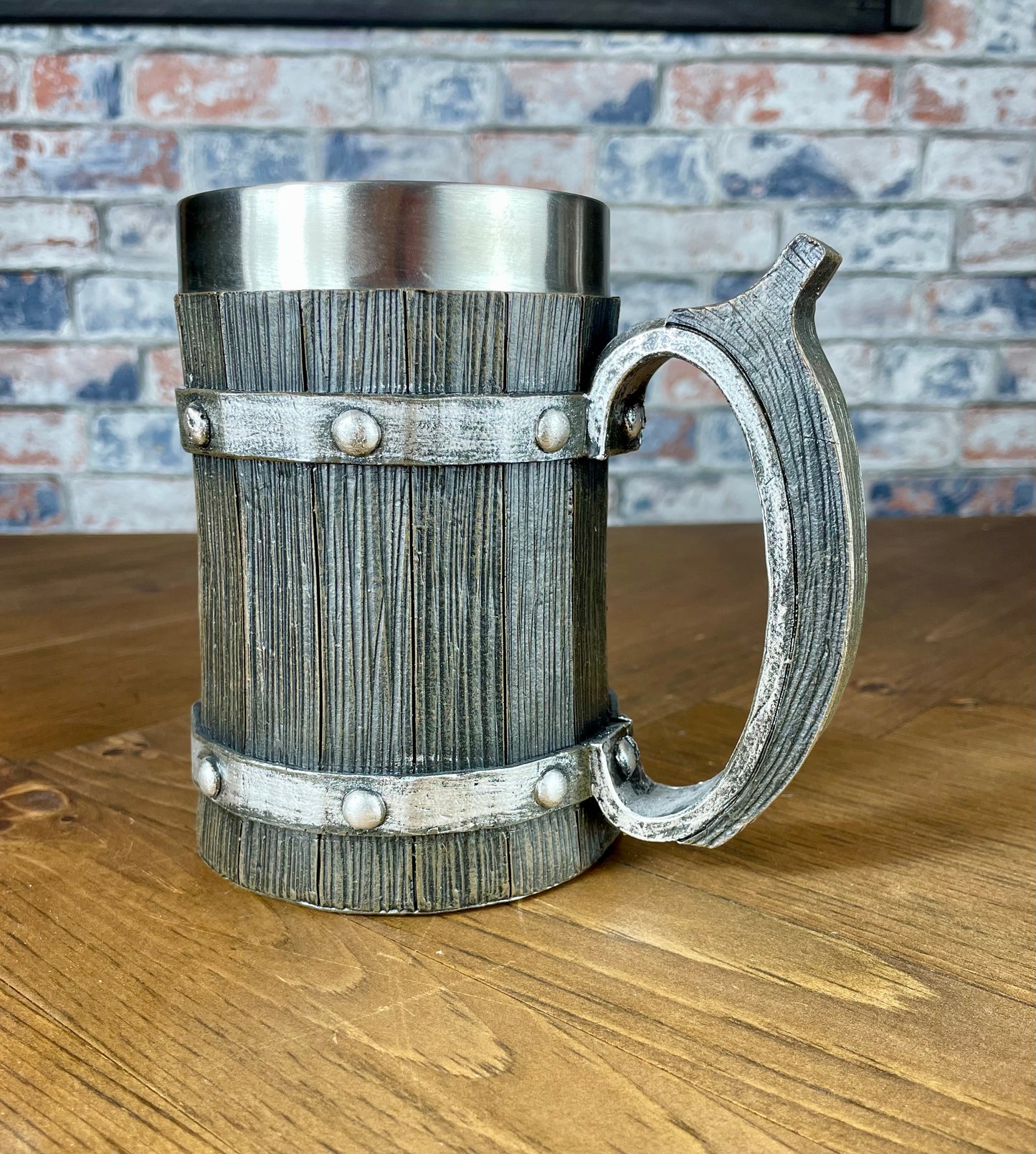 Medieval Viking Style Decorative Resin Drinking Tankard With Stainless Steel Insert. Drink in style with our highly decorative tankard with wood effect panels, metal banding and rustic style handle. Holding 500ml you can drink with your clan in style. Perfect for decorating home bars, cosplay, tabletop gaming and all fans of Norse mythology, and medieval and fantasy decoration.