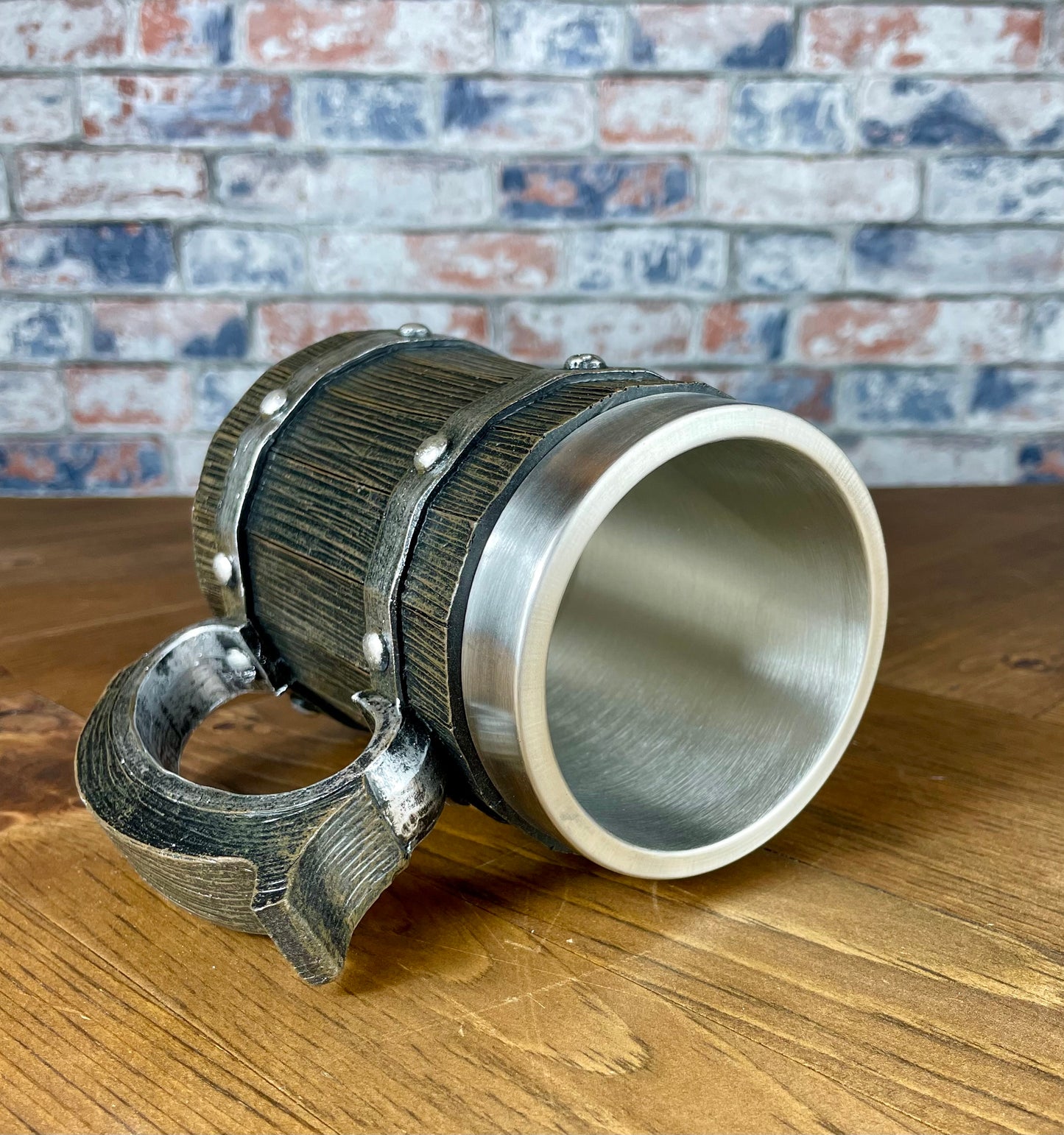 Medieval Viking Style Decorative Resin Drinking Tankard With Stainless Steel Insert. Drink in style with our highly decorative tankard with wood effect panels, metal banding and rustic style handle. Holding 500ml you can drink with your clan in style. Perfect for decorating home bars, cosplay, tabletop gaming and all fans of Norse mythology, and medieval and fantasy decoration.