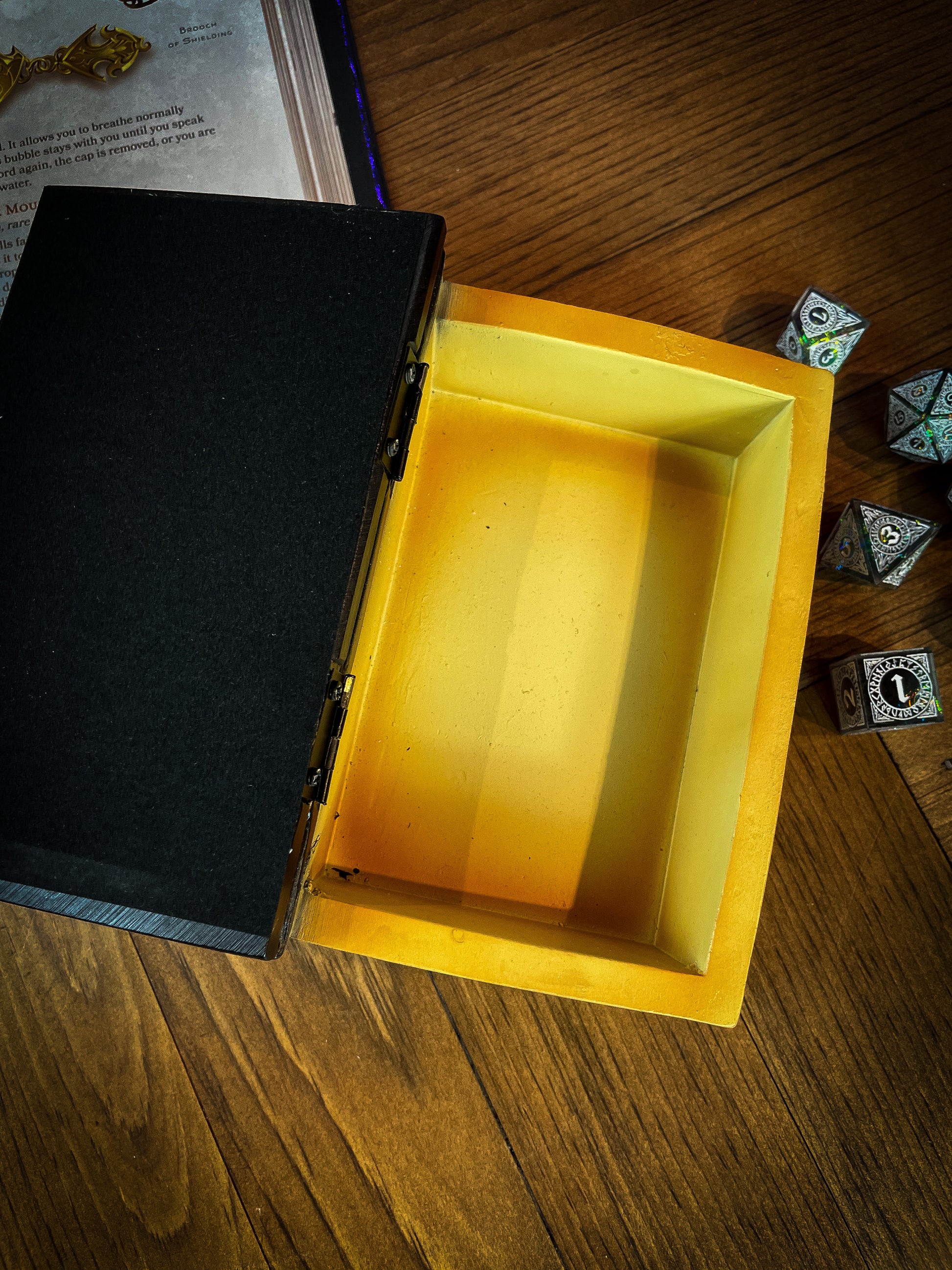 This fantastic box can subtly blend into any arcane library. Taking form of an ancient book, bound in black leather. The lid of the box features a raised golden pentagram with detailed patterns decorating the top and bottom of the cover. Free UK Delivery with Fandomonium