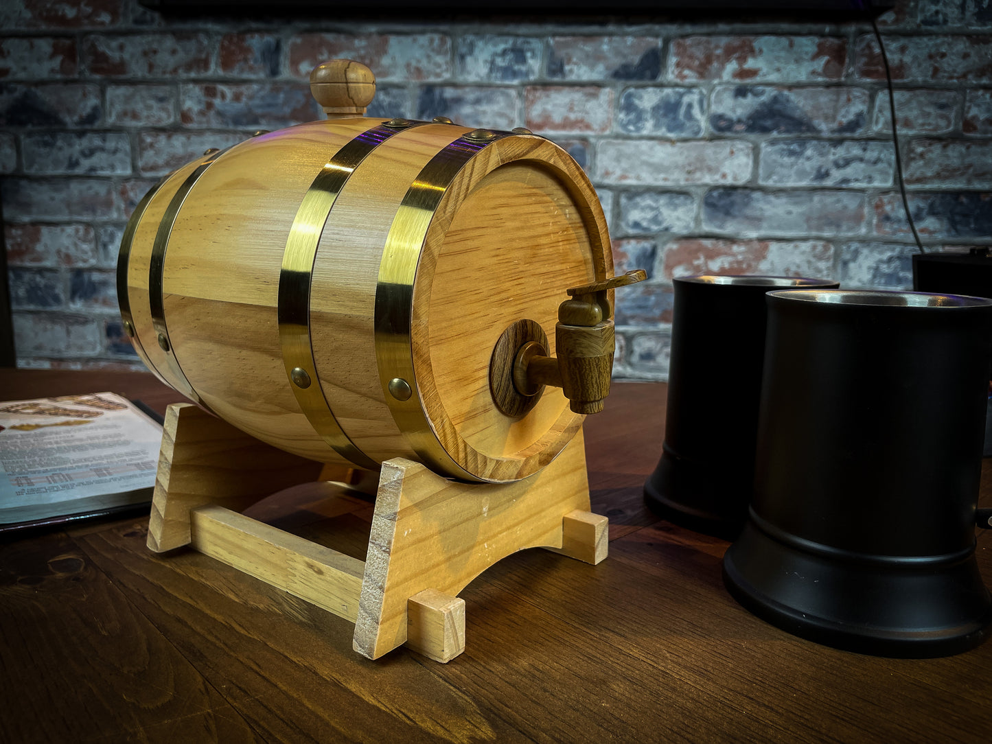 1.5L solid wood beer and wine barrel with tap. Perfect for holding your beverage of choice and maintaining your tavern feel around your table. Featuring a removable tap to fill your plastic lined barrel it is super easy to refill and wash out. Also comes with a wooden stand to hold your barrel in place. Free UK Delivery with Fandomonium