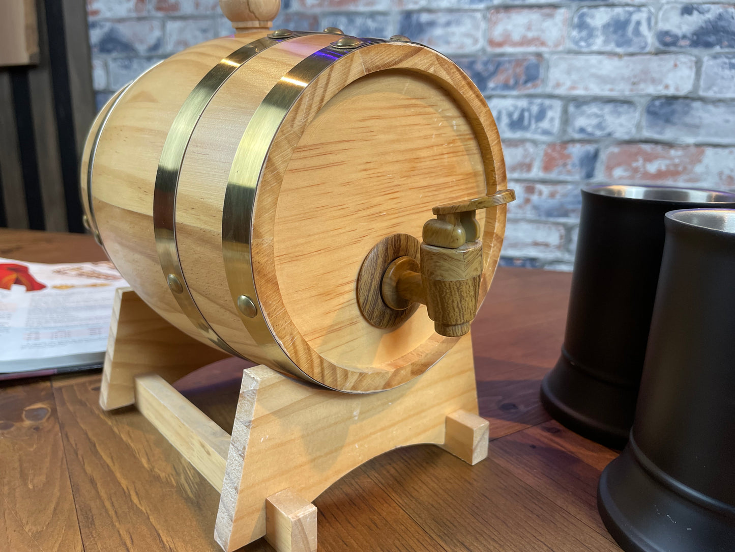 1.5L solid wood beer and wine barrel with tap. Perfect for holding your beverage of choice and maintaining your tavern feel around your table. Featuring a removable tap to fill your plastic lined barrel it is super easy to refill and wash out. Also comes with a wooden stand to hold your barrel in place. Free UK Delivery with Fandomonium