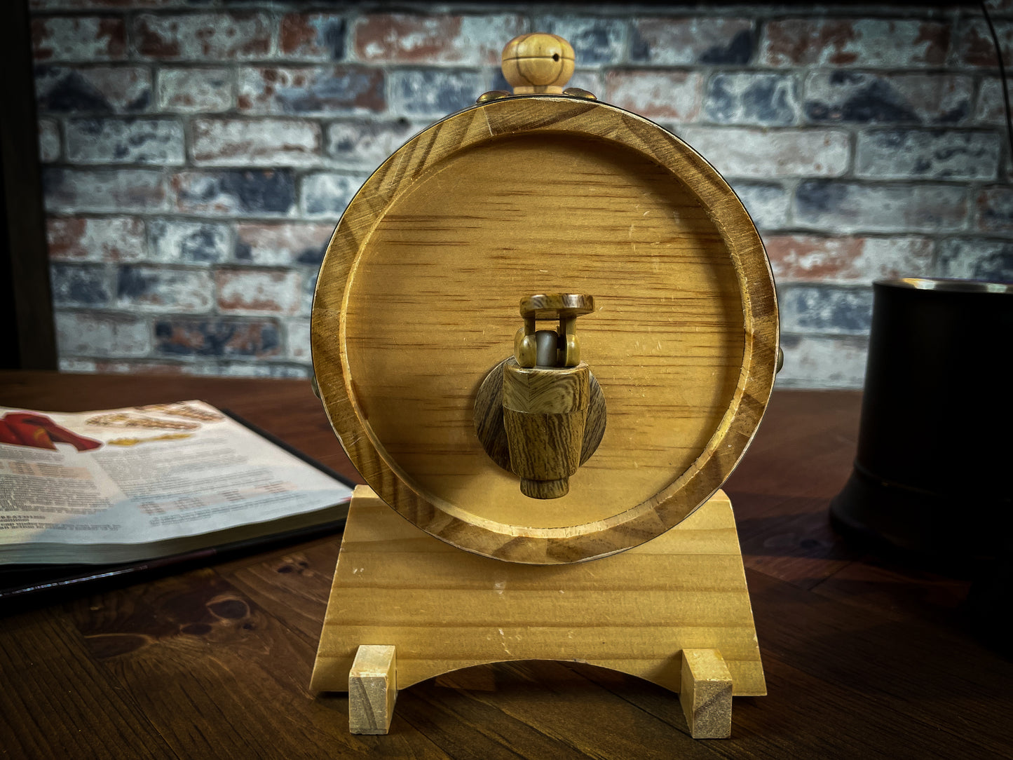 1.5L solid wood beer and wine barrel with tap. Perfect for holding your beverage of choice and maintaining your tavern feel around your table. Featuring a removable tap to fill your plastic lined barrel it is super easy to refill and wash out. Also comes with a wooden stand to hold your barrel in place. Free UK Delivery with Fandomonium