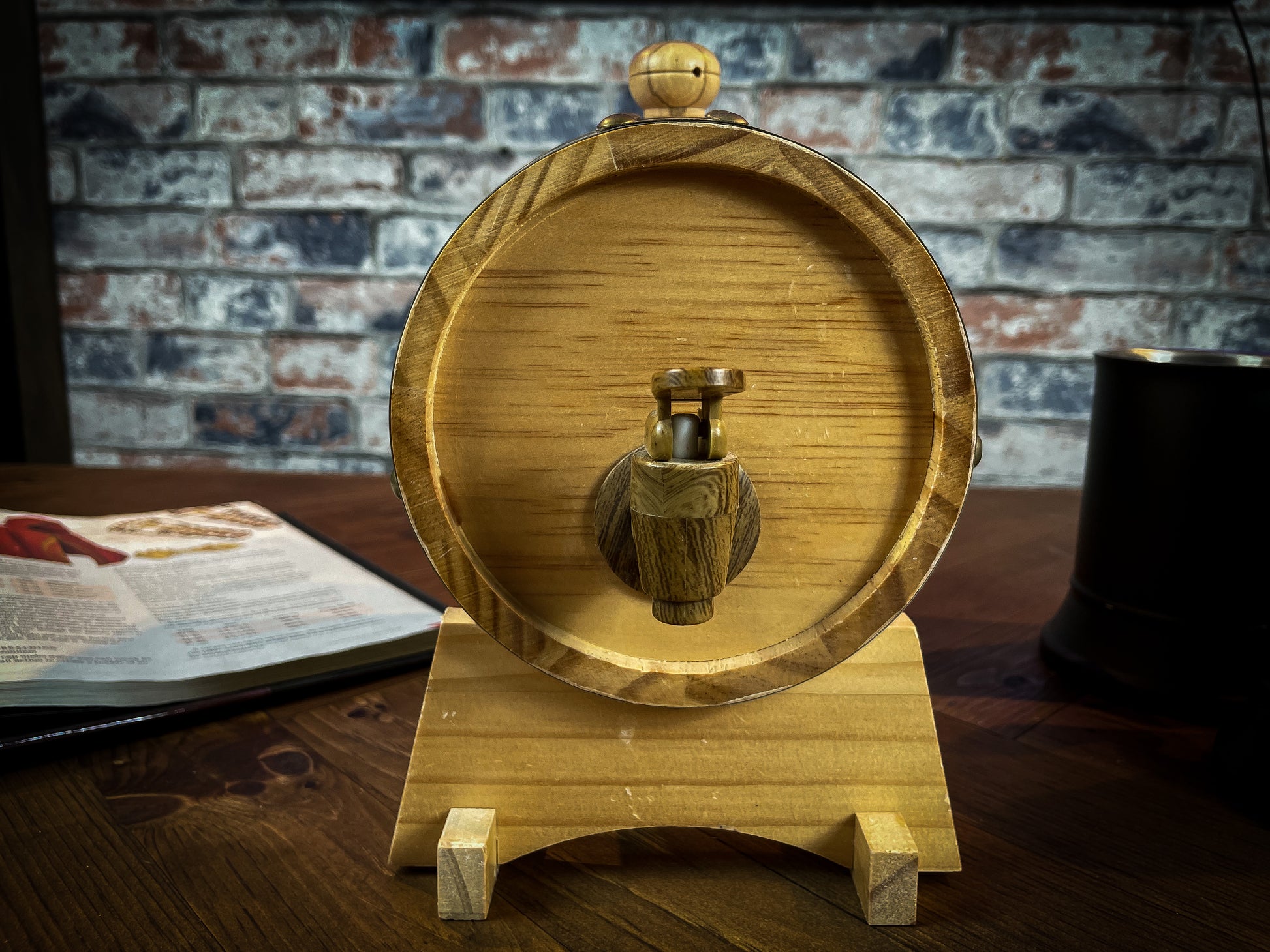 1.5L solid wood beer and wine barrel with tap. Perfect for holding your beverage of choice and maintaining your tavern feel around your table.  Featuring a removable tap to fill your plastic lined barrel it is super easy to refill and wash out. Also comes with a wooden stand to hold your barrel in place. Free UK Delivery with Fandomonium