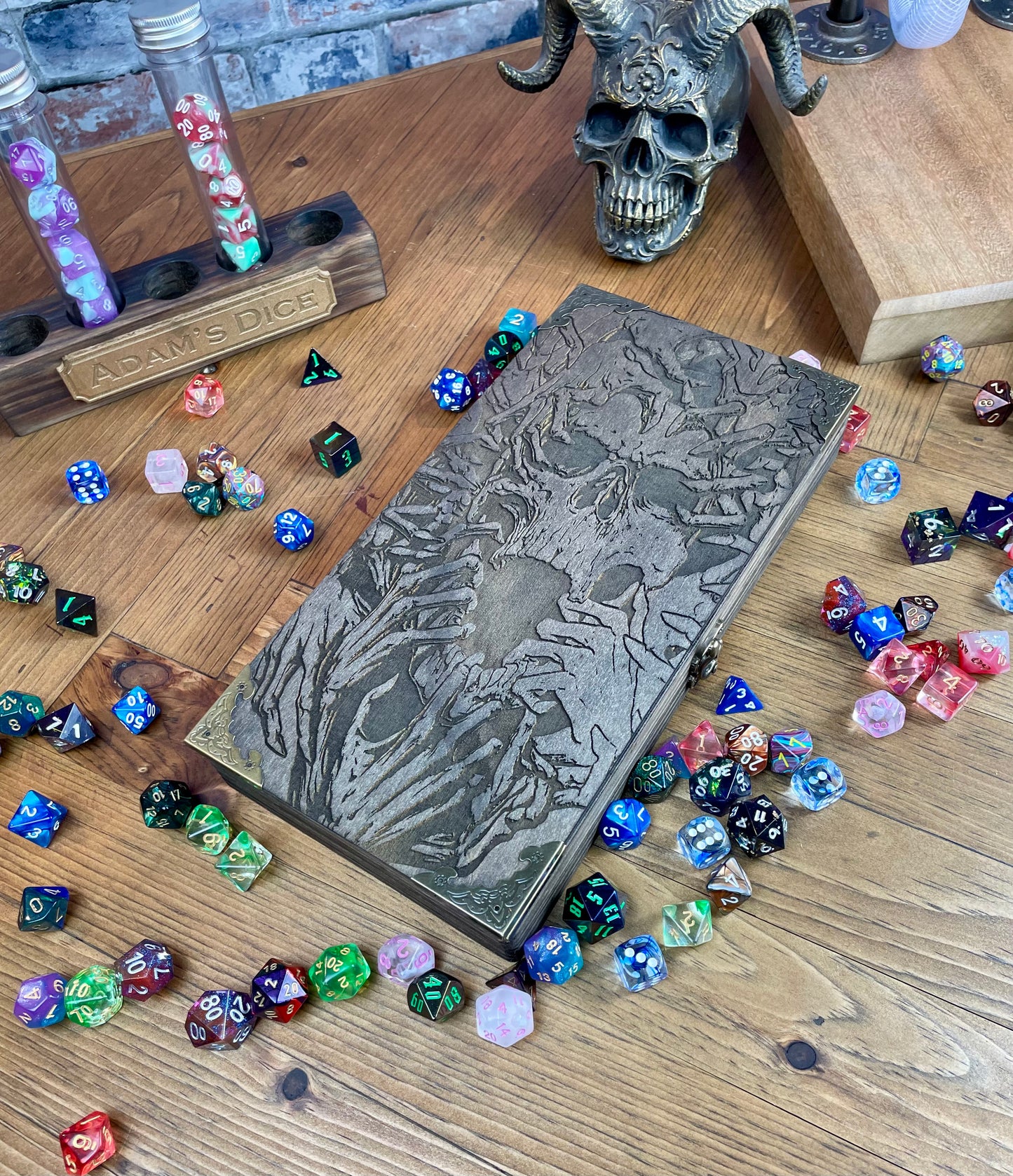 Necromancers Vault Dice Box, Accessory Storage and Roll Tray. Hand finished dice box for storing dice, cards, counters and accessories with handy pen storage and in built roll tray. Choose from 8 vibrant colour finished to make your box unique to you. Complete with our unique necromancy inspired design, metal corner protectors and clasp