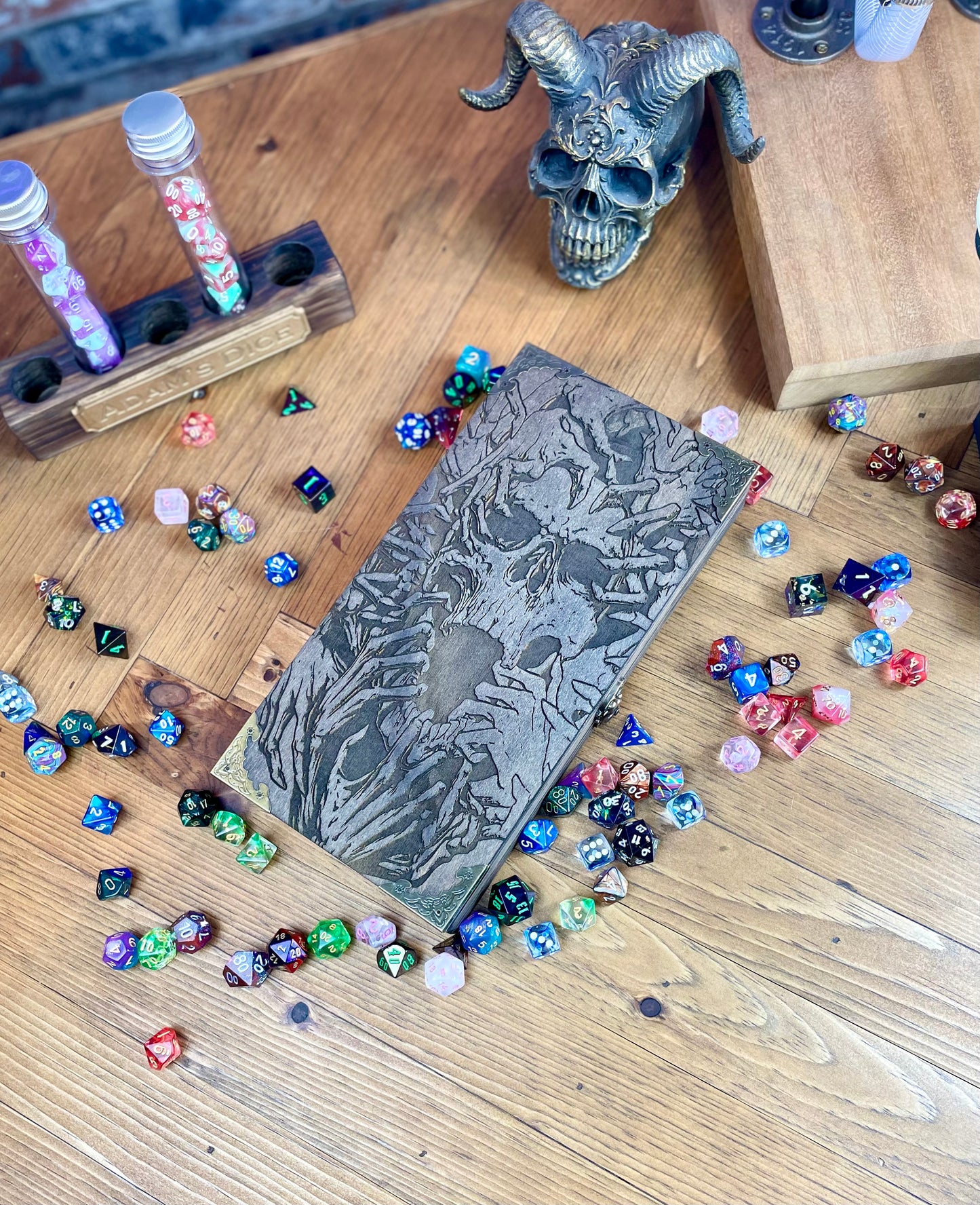 Necromancers Vault Dice Box, Accessory Storage and Roll Tray. Hand finished dice box for storing dice, cards, counters and accessories with handy pen storage and in built roll tray. Choose from 8 vibrant colour finished to make your box unique to you. Complete with our unique necromancy inspired design, metal corner protectors and clasp