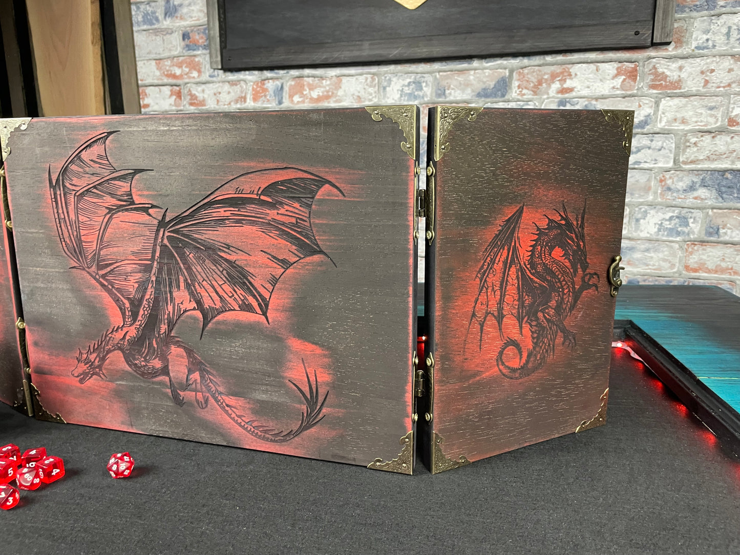 Fire Dragon DM Screen Our brand new addition to our range of screens Featuring our 3 fire dragons, the screen's 3 sections fold on hinges and has an antique effect catch for easy storage. Each screen is painted black before accenting the design in one of 4 vibrant colours; red, green, blue or purple. We embellish the DM screen with antiqued corner protectors to save you from bumps and scrapes. 
