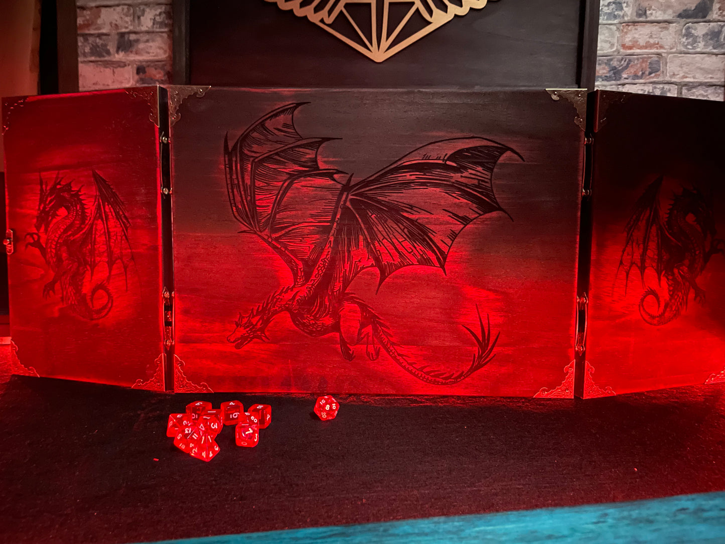 Fire Dragon DM Screen Our brand new addition to our range of screens Featuring our 3 fire dragons, the screen's 3 sections fold on hinges and has an antique effect catch for easy storage. Each screen is painted black before accenting the design in one of 4 vibrant colours; red, green, blue or purple. We embellish the DM screen with antiqued corner protectors to save you from bumps and scrapes. 