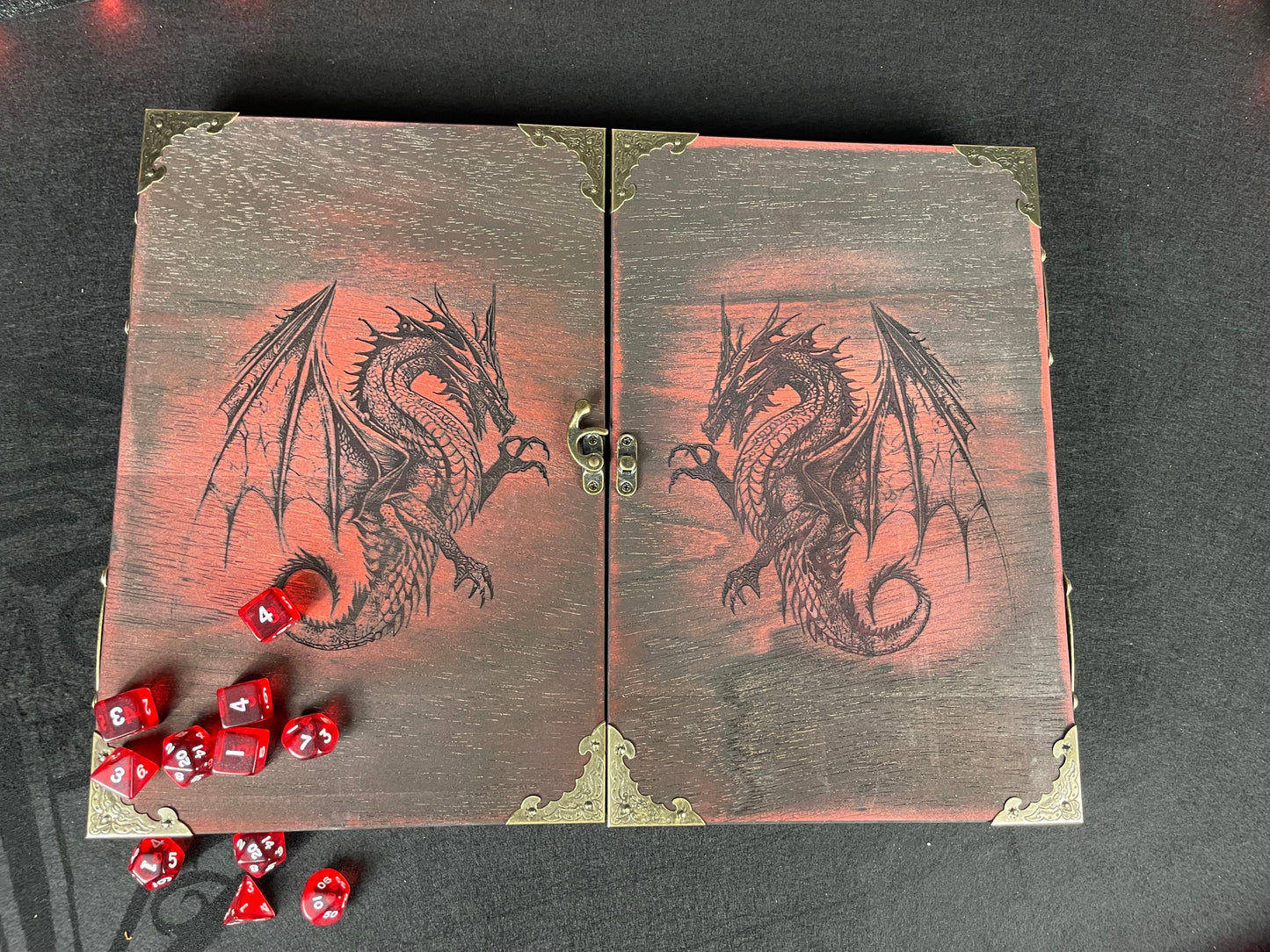 Fire Dragon DM Screen Our brand new addition to our range of screens Featuring our 3 fire dragons, the screen's 3 sections fold on hinges and has an antique effect catch for easy storage. Each screen is painted black before accenting the design in one of 4 vibrant colours; red, green, blue or purple. We embellish the DM screen with antiqued corner protectors to save you from bumps and scrapes. 