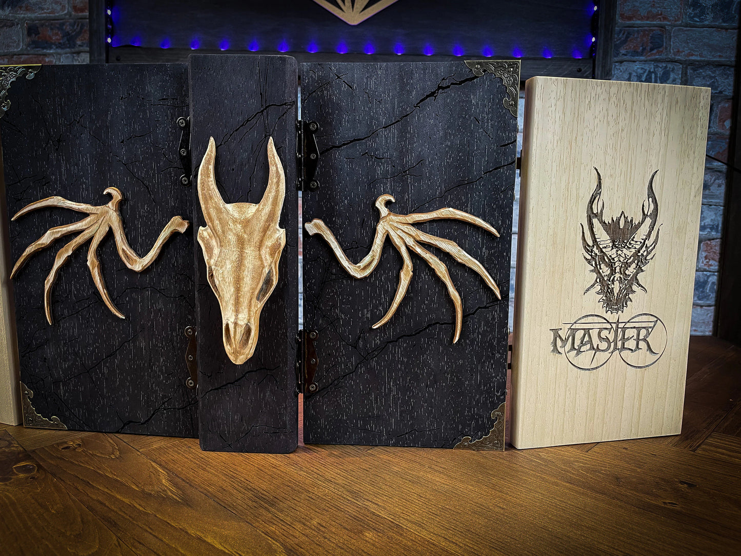 Dragon's Wrath Dungeon Master Screen. Made from solid wood and made to fold to resemble a book when not in use, this screen is stylish, fun and adds atmosphere to any game. Comprising 4 solid wood panels connected using antiqued metal hinges; they fold together to resemble a book when closed. Free UK delivery from Fandomonium