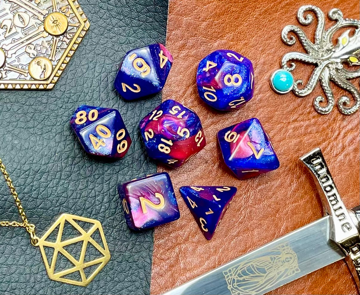 Rose Galaxy Polyhedral Dice Set Traverse the stars with these red and blue swirl resin polyhedral dice set. They are standard 16mm polyhedral dice sets perfect for Tabletop games and RPG's such as pathfinder or dungeons and dragons. This set includes one of each D20, D12, D10, D%, D8, D6, D4.