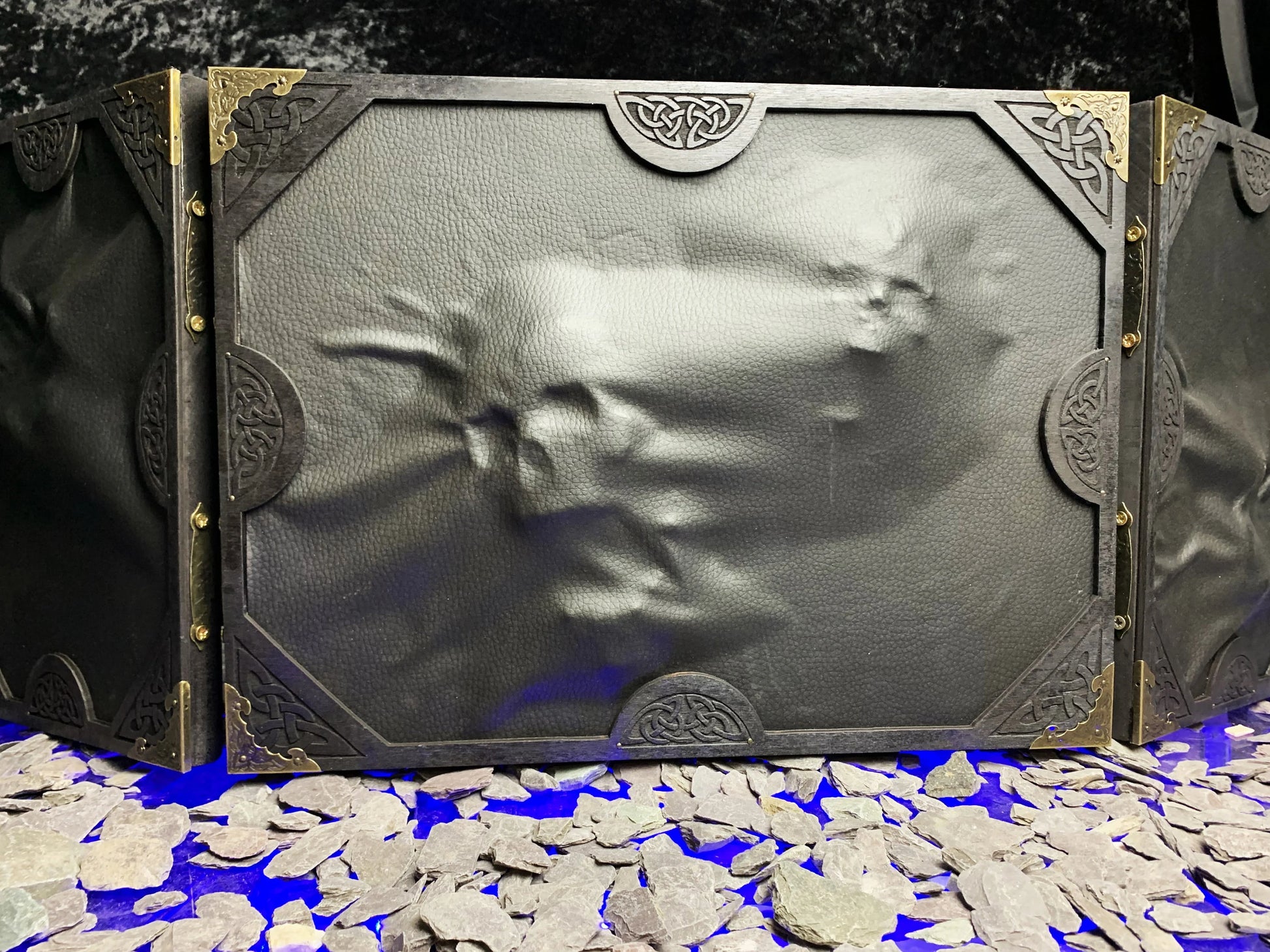 The Screen Of Trapped Souls Dungeon Master Screen  Beware the screen of trapped souls!  Made from solid wood with a black PU leather front; this screen is made to create atmosphere at your table. Complete with 3D skulls and hands protruding from the screen itself; stretching very planes of existence to escape!